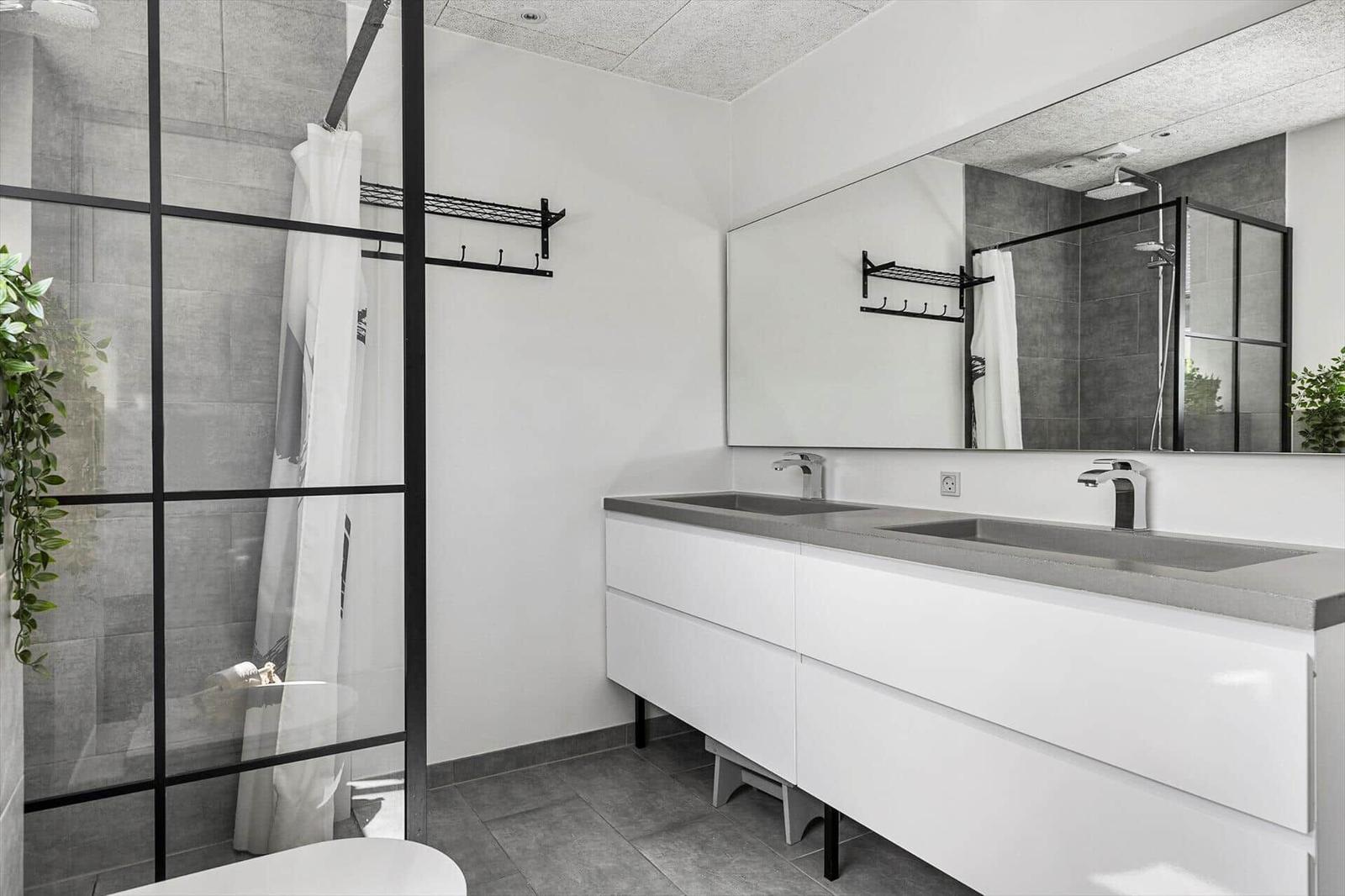 Bathroom with shower, sink, and mirror