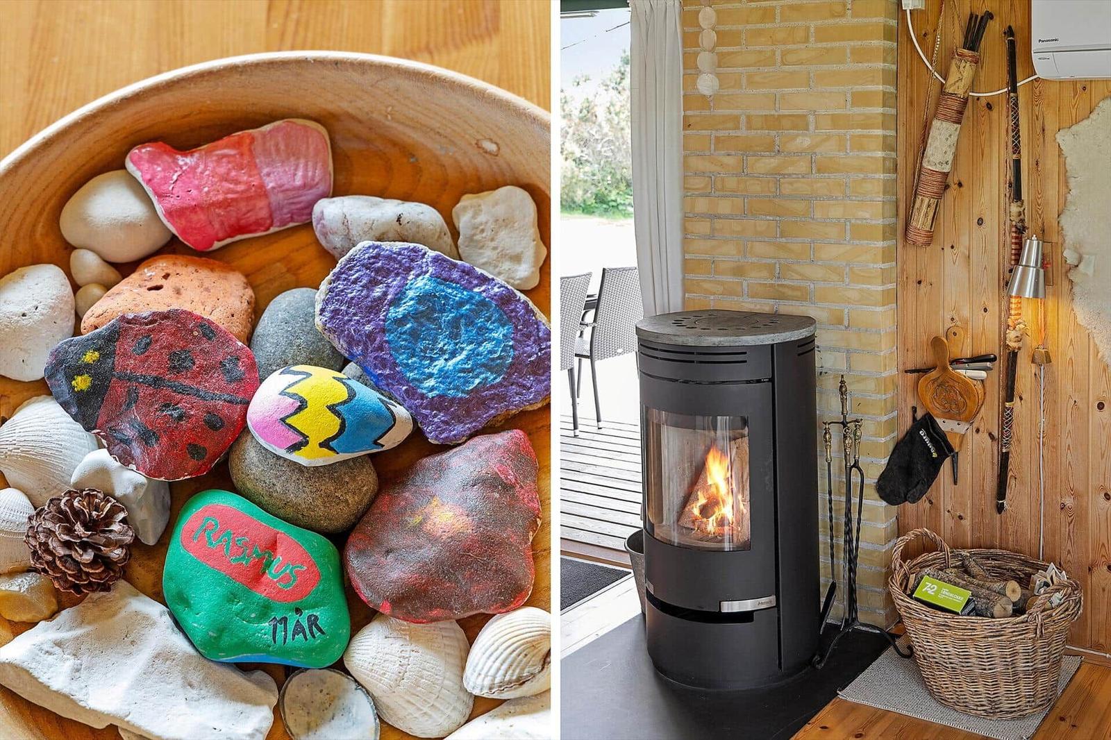Painted stones in a wooden bowl and a lit fireplace in the living area.