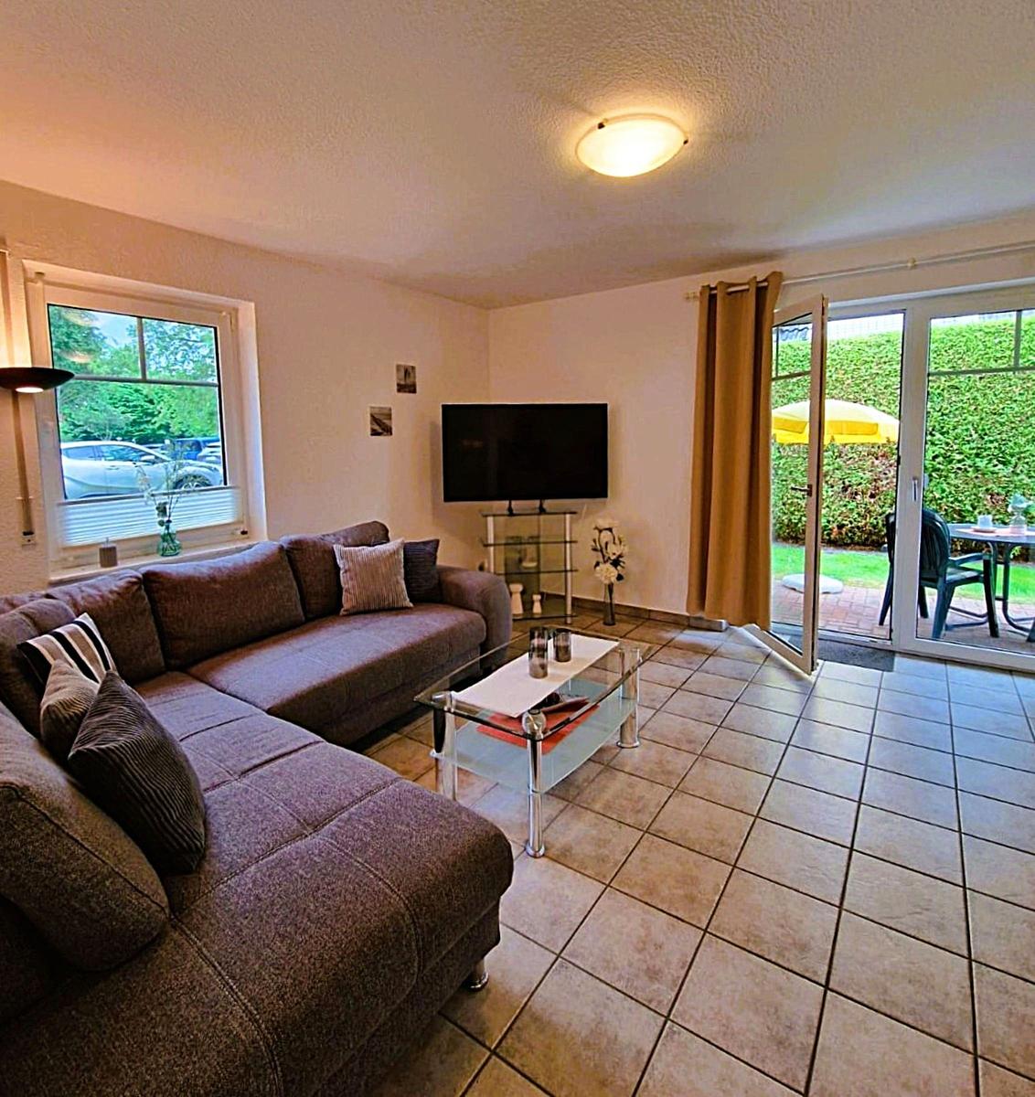 Living room with sofa, TV, and terrace