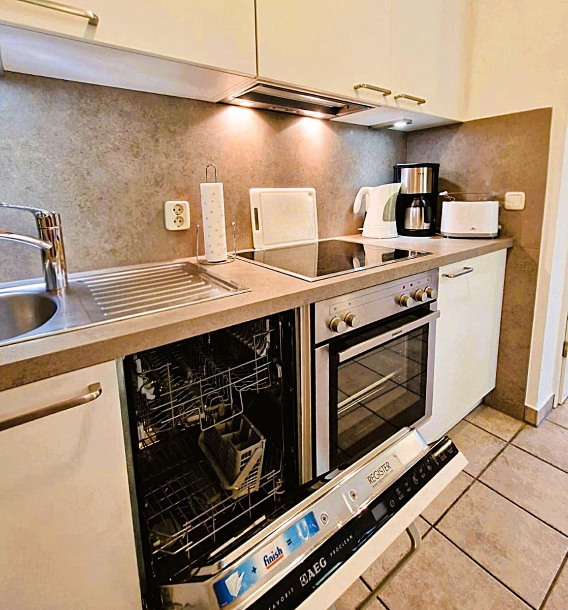 Kitchen with sink, range hood, stove, oven, and dishwasher.