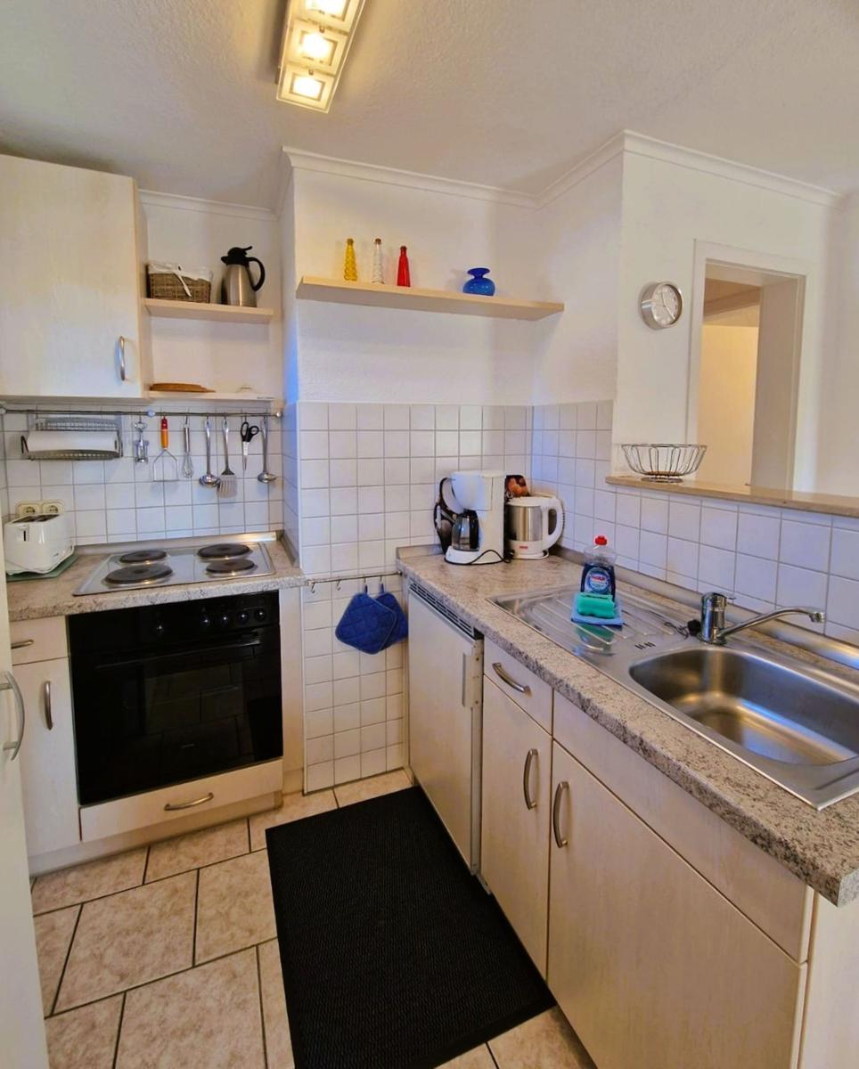Kitchen with stove, sink, and work surfaces