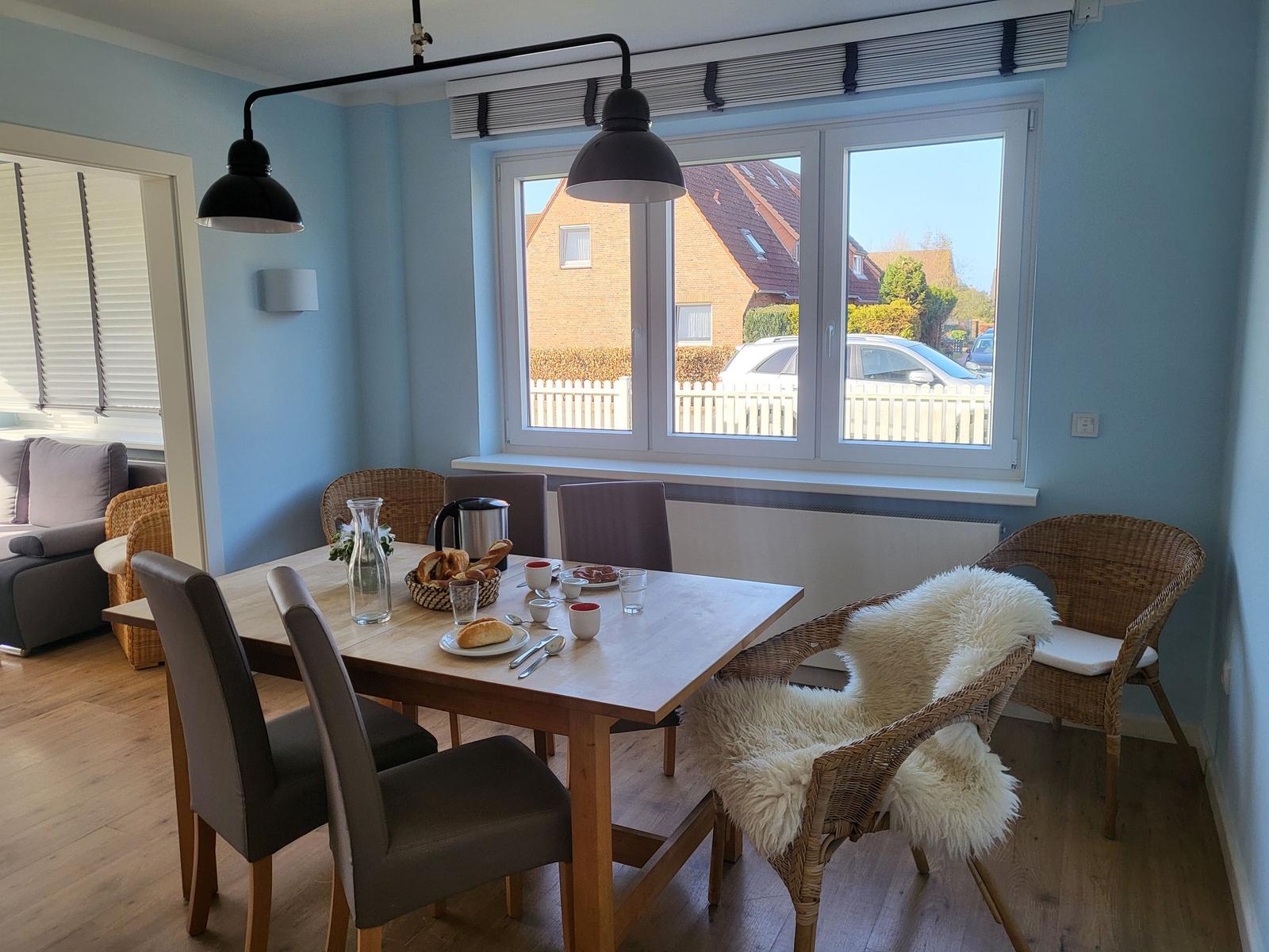 Dining area with table, chairs, and street view through window