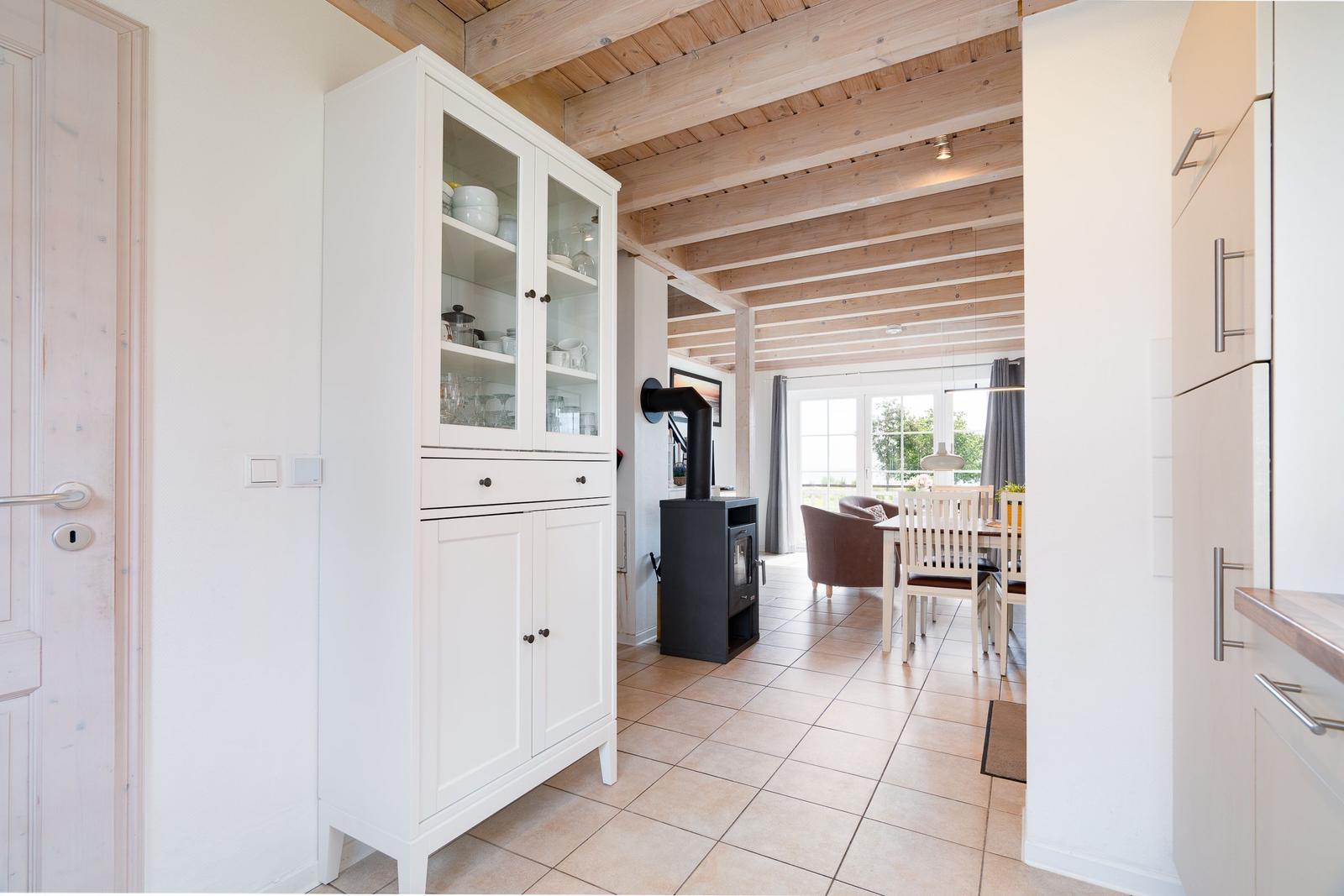 House with dining area, wooden ceiling, and kitchen. View into living and dining area.