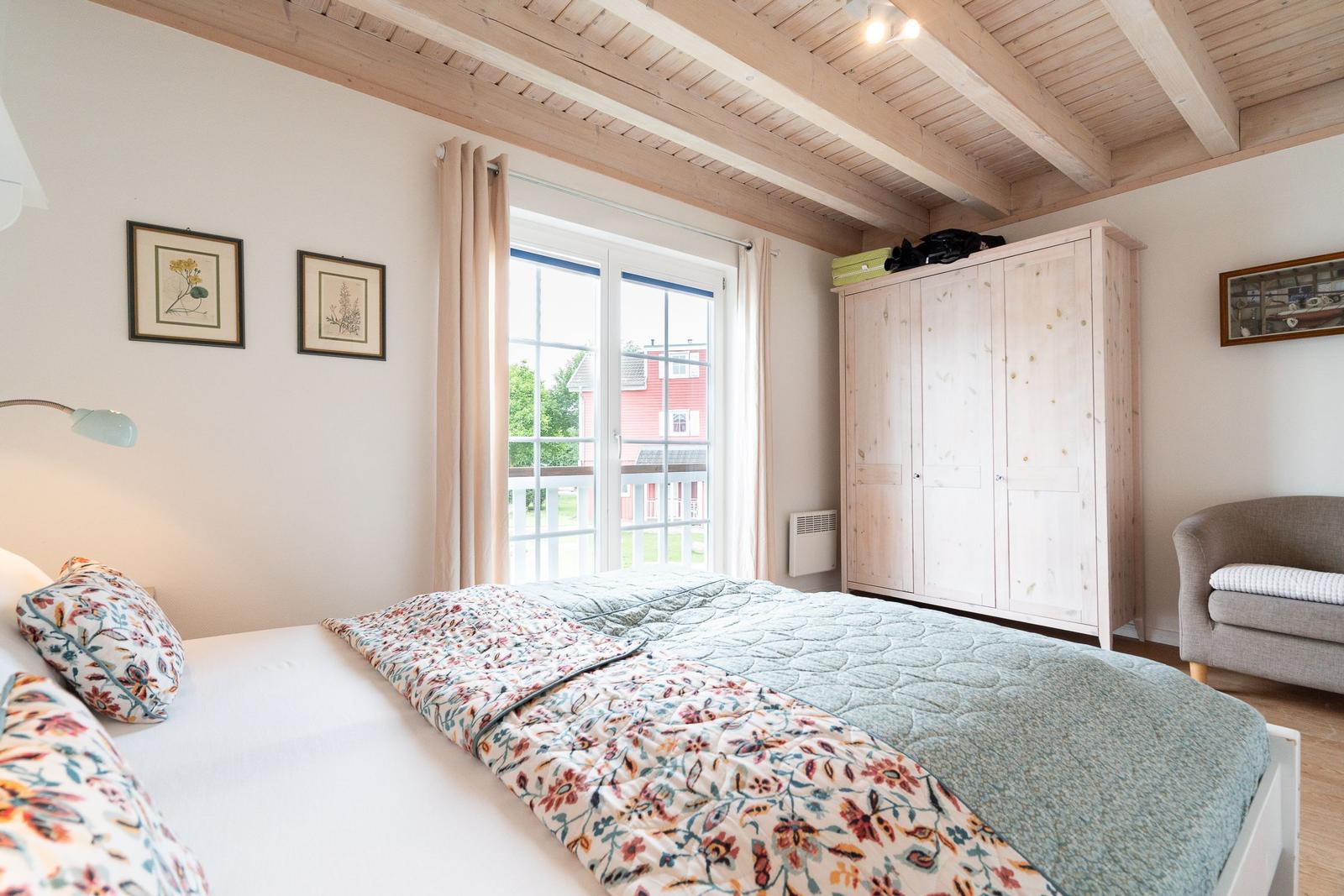 Bedroom with bed, wardrobe, and window to terrace