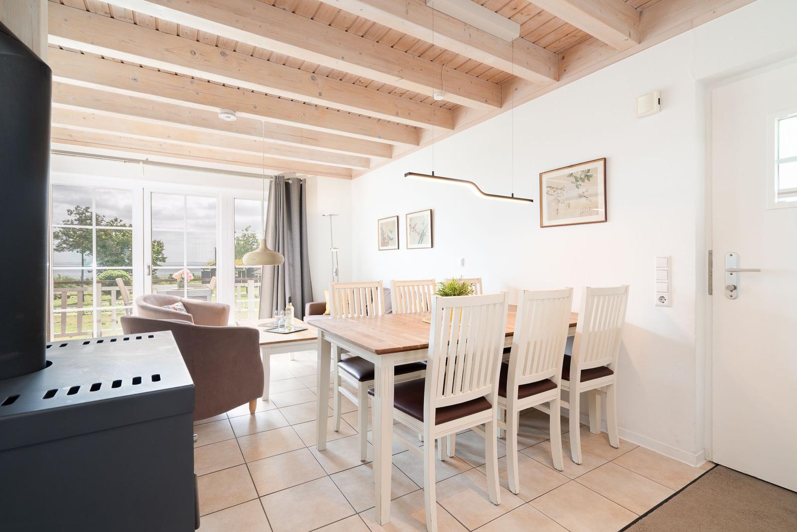 Dining room with table, chairs, and view of balcony