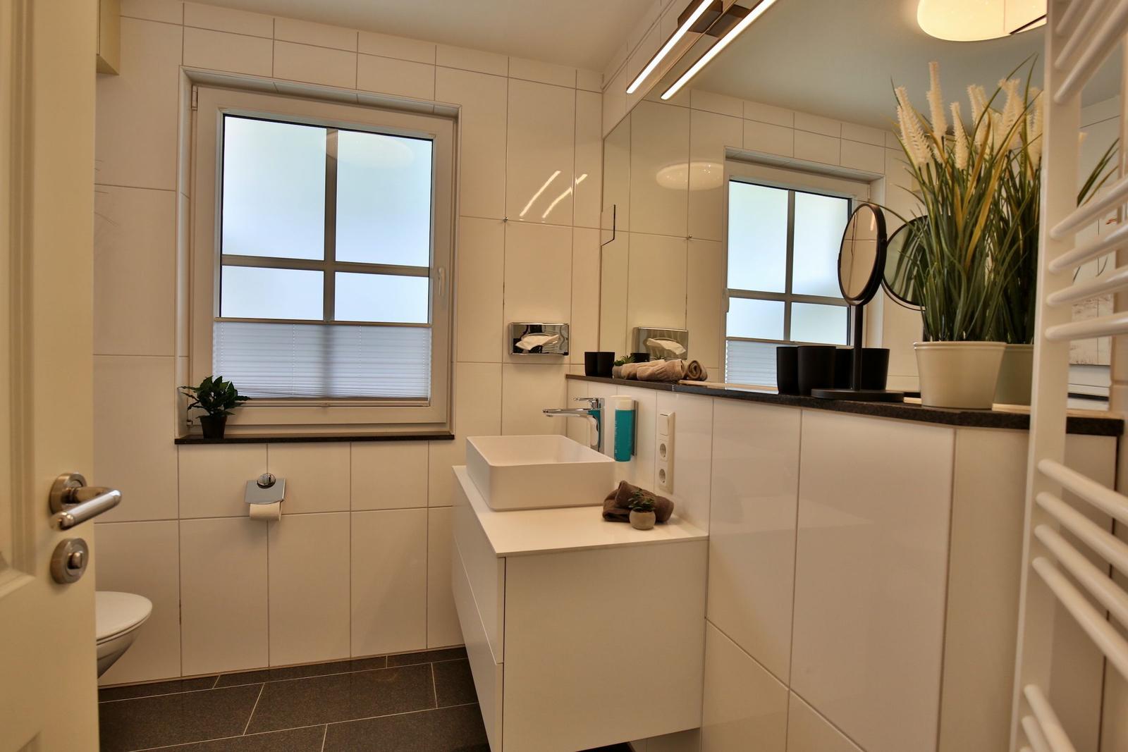 Bathroom with window, sink, and heater