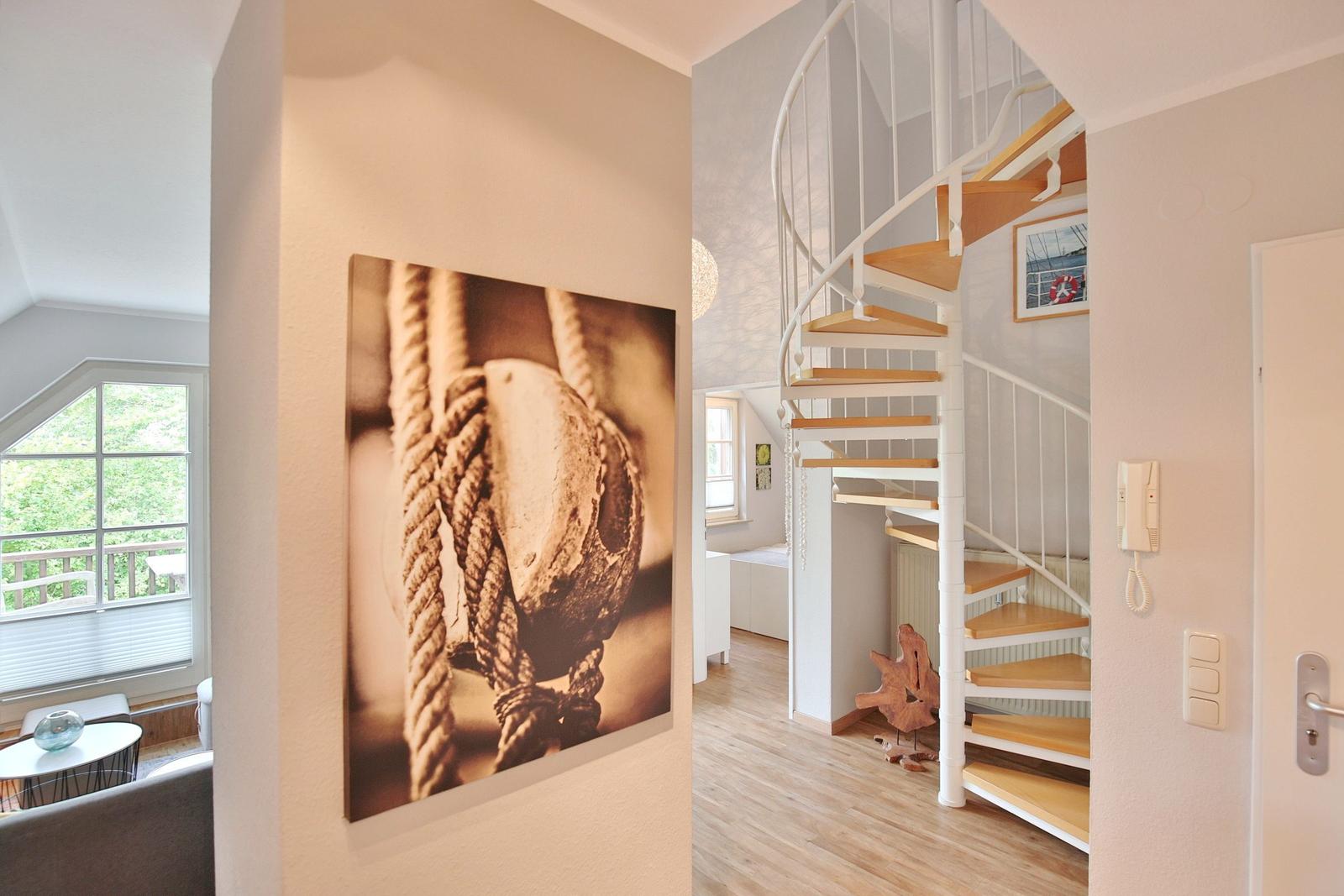 House with spiral staircase, wall picture, and view of balcony