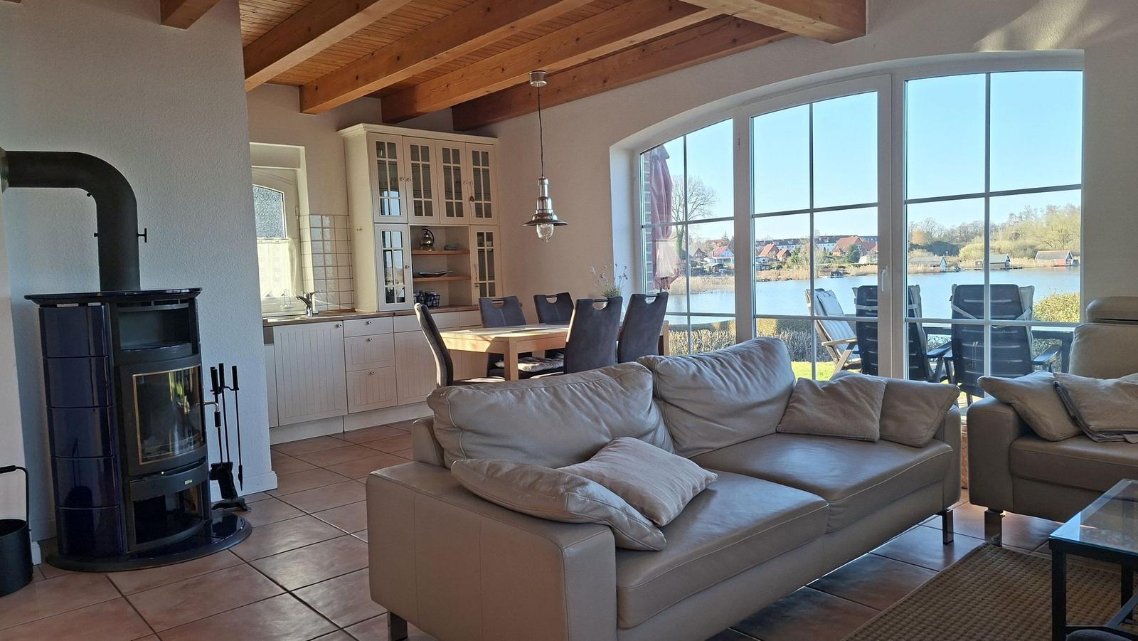 Living area with sofa, fireplace, and view of the lake.