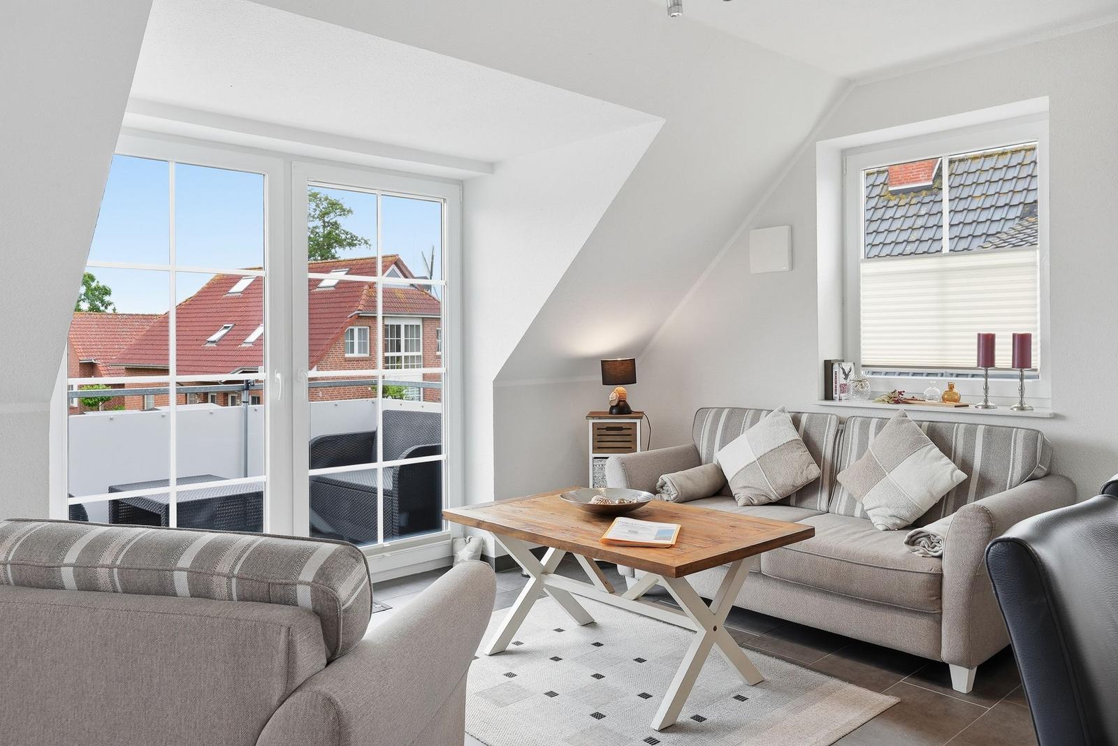 Living room with sofa, table, and view of terrace and roof