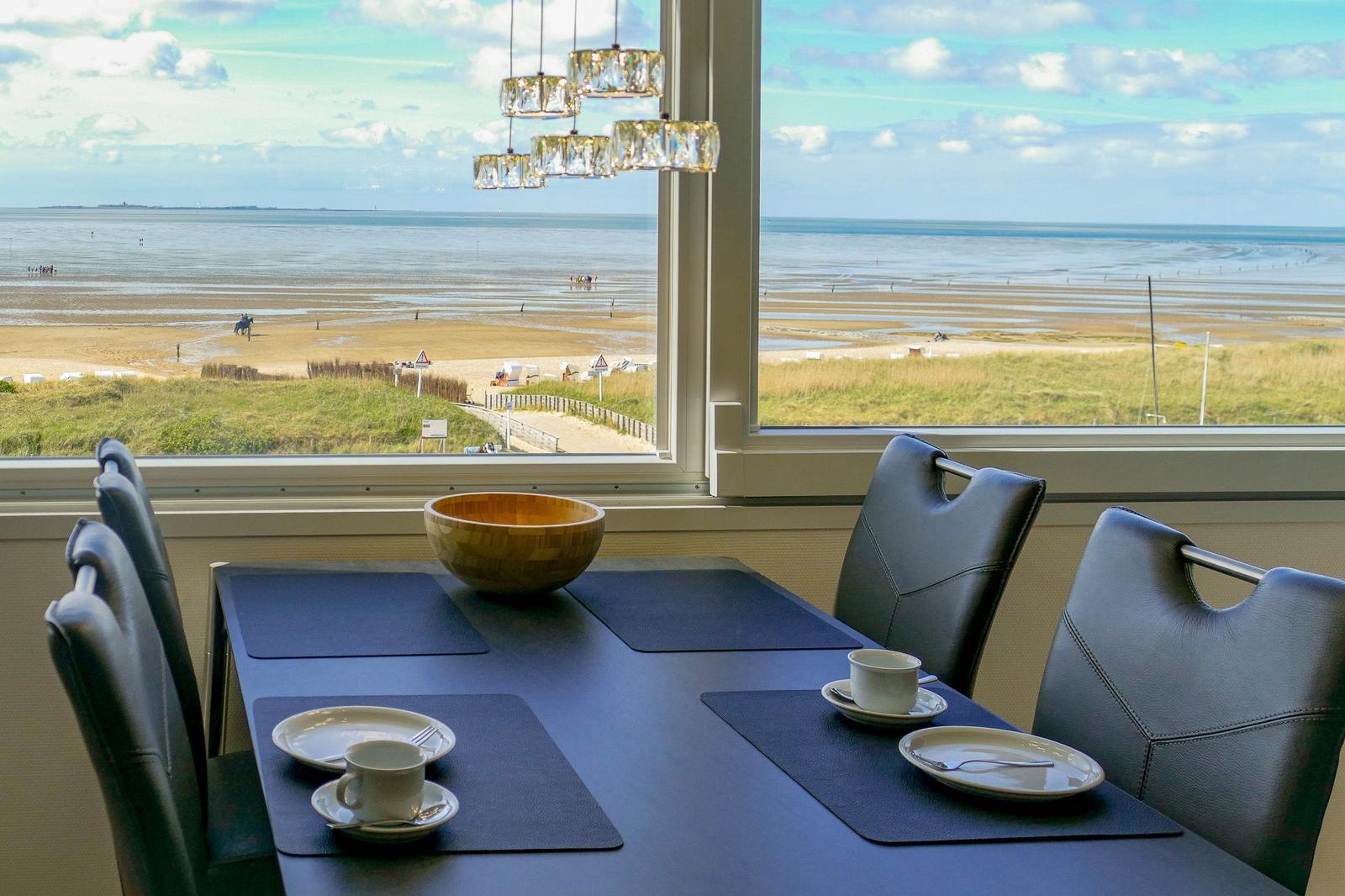 Dining table with view of beach and sea