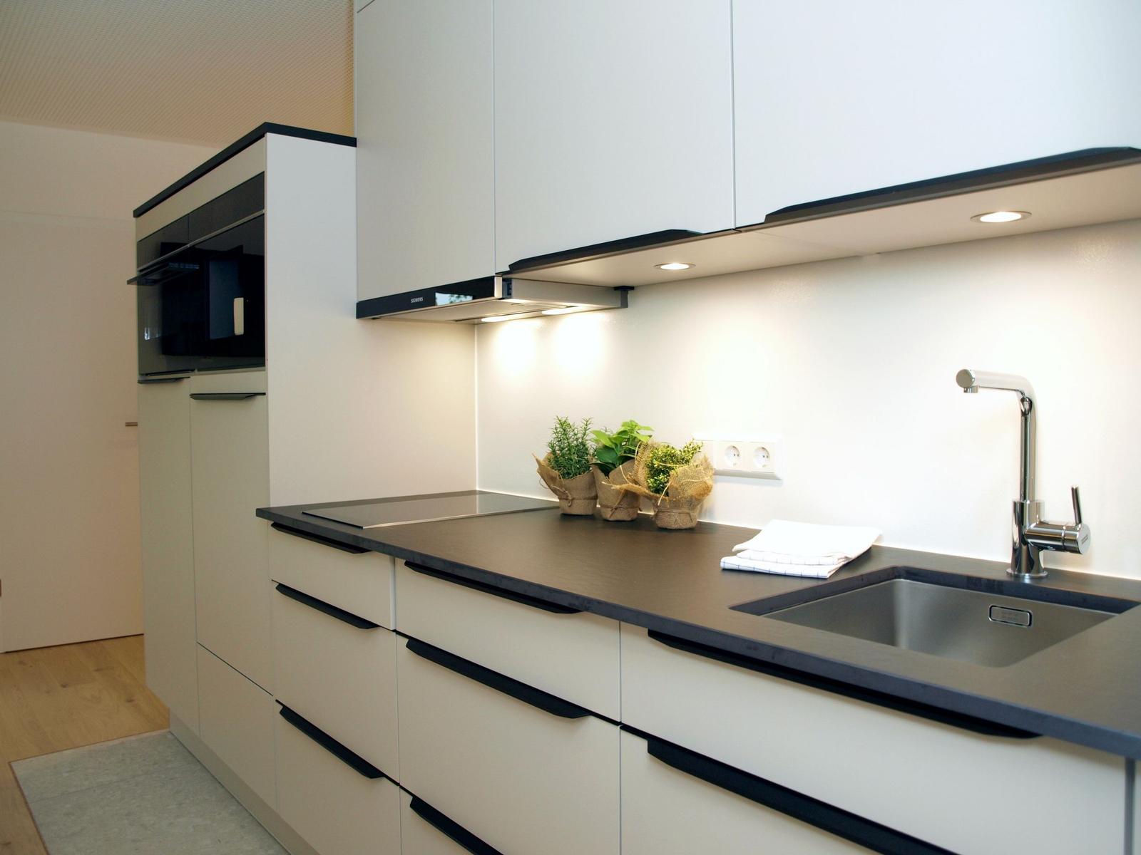 Moderne Küche mit Arbeitsplatte, Spüle und Küchenzeile.