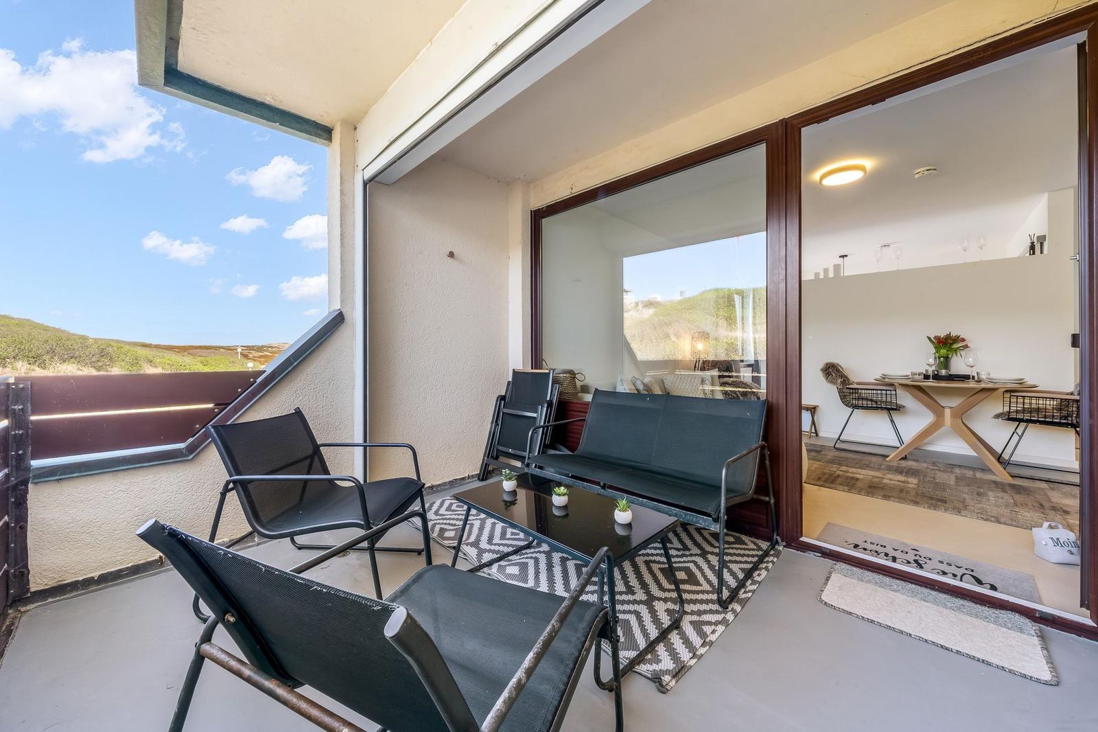 Terrace with seating area and view of the landscape.