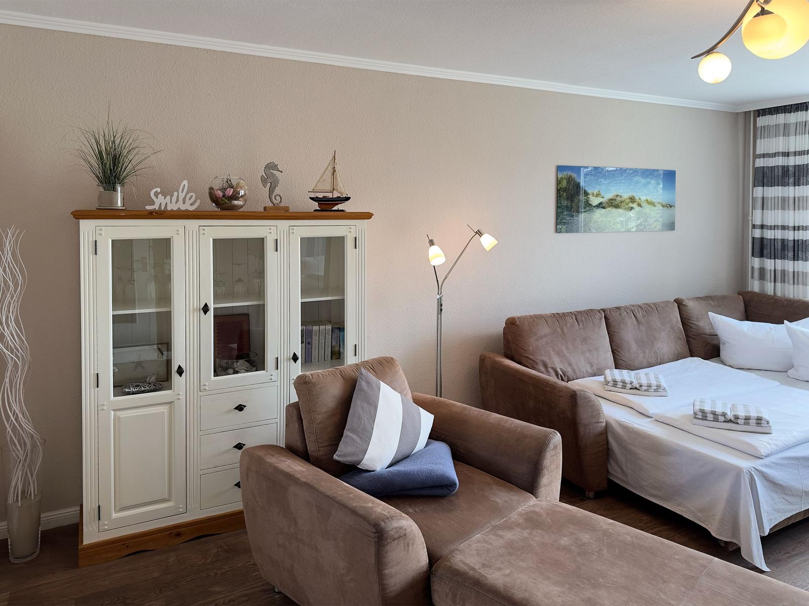 Living room with sofa, cabinet, and wall art