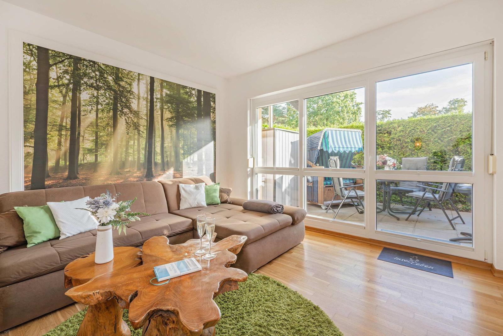 Living room with sofa, wooden table, and view of the terrace.