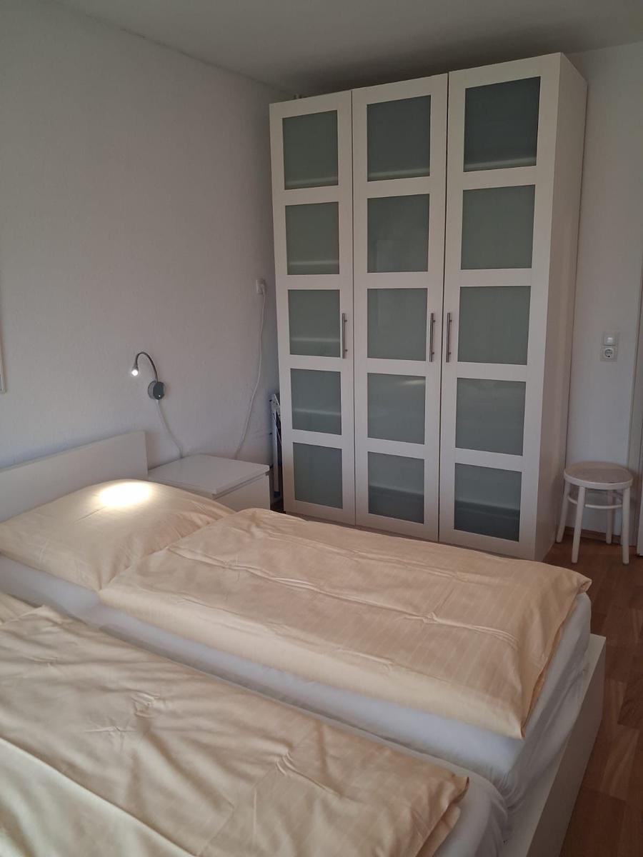 Bedroom with double bed, wardrobe, and nightstand