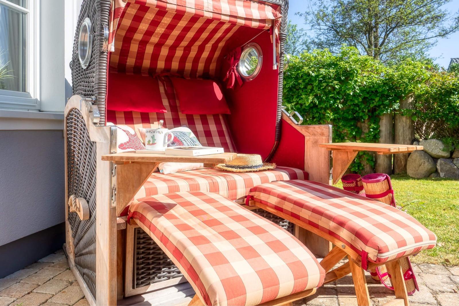 Red lounge chair with checkered fabric and sunshade in the garden