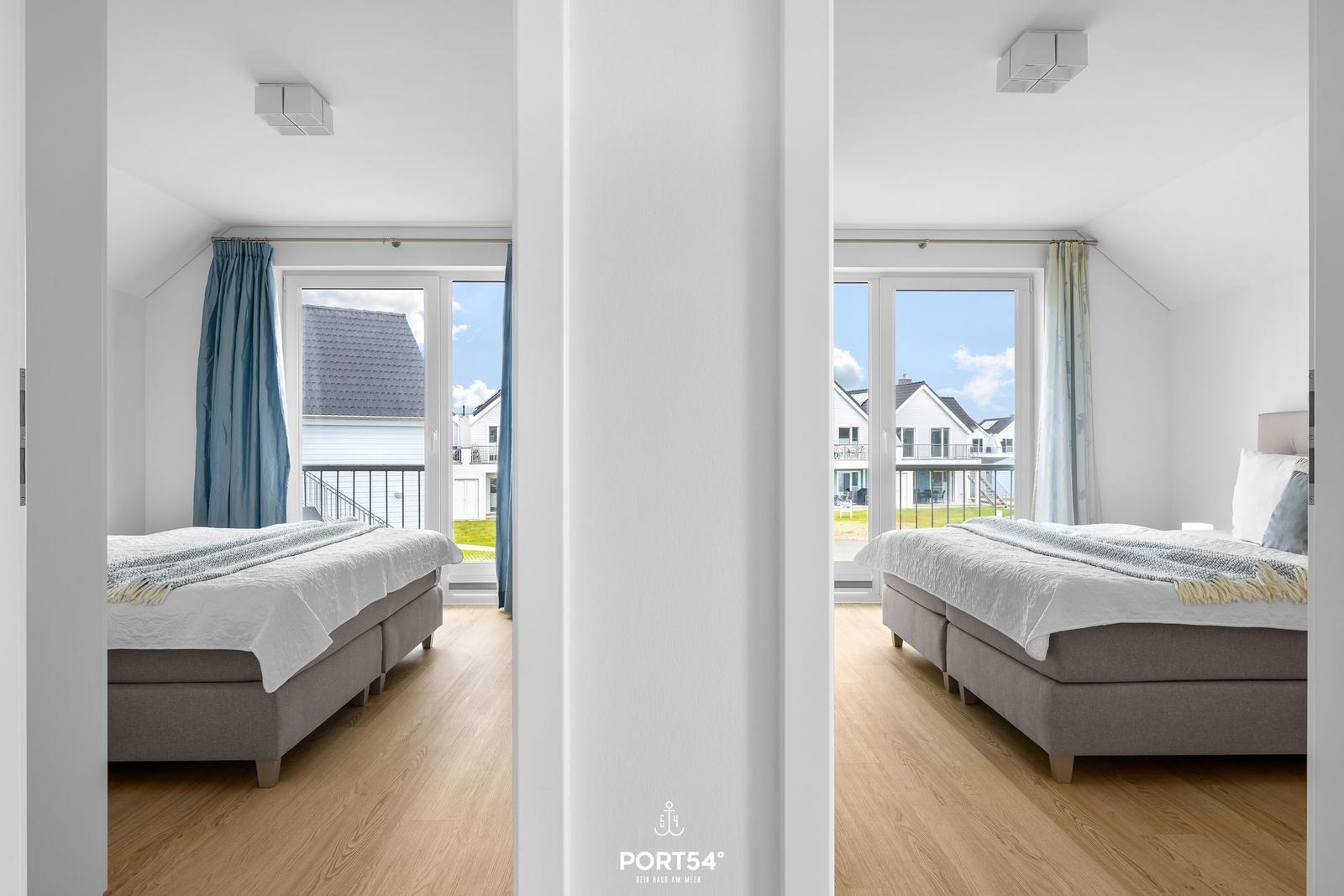 Zwei Schlafzimmer mit Balkon und Blick auf die Umgebung.