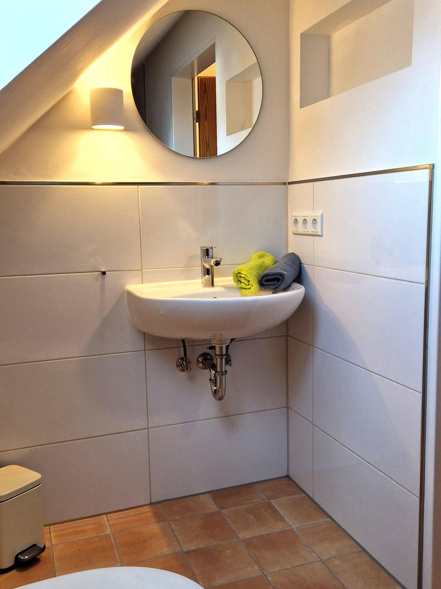 Bathroom with sink, mirror, and towels