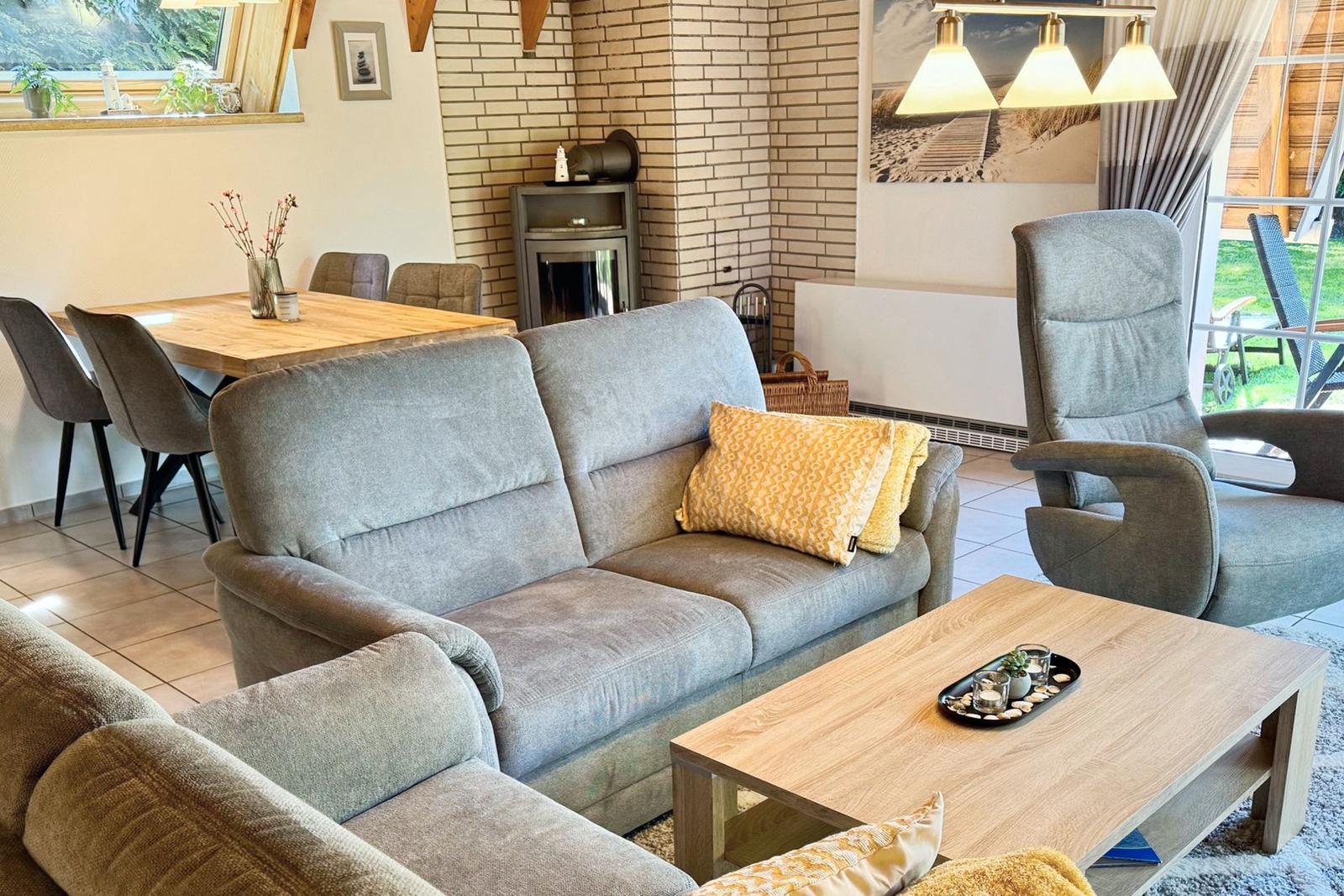 Living and dining area with sofa, dining table, and fireplace