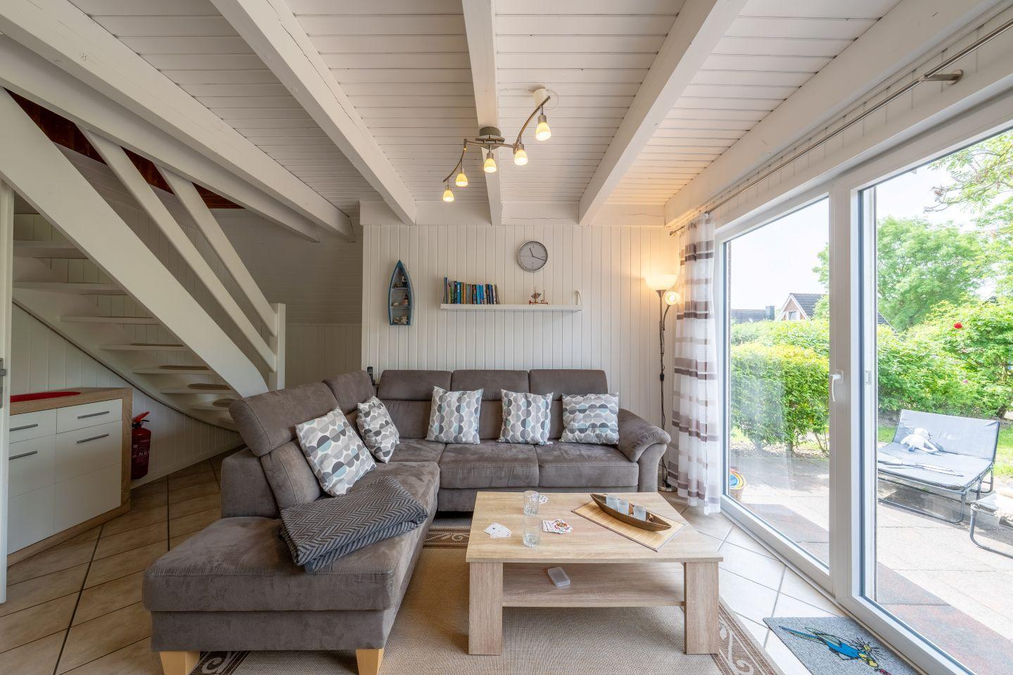 Living room with sofa, table, and view of the terrace.