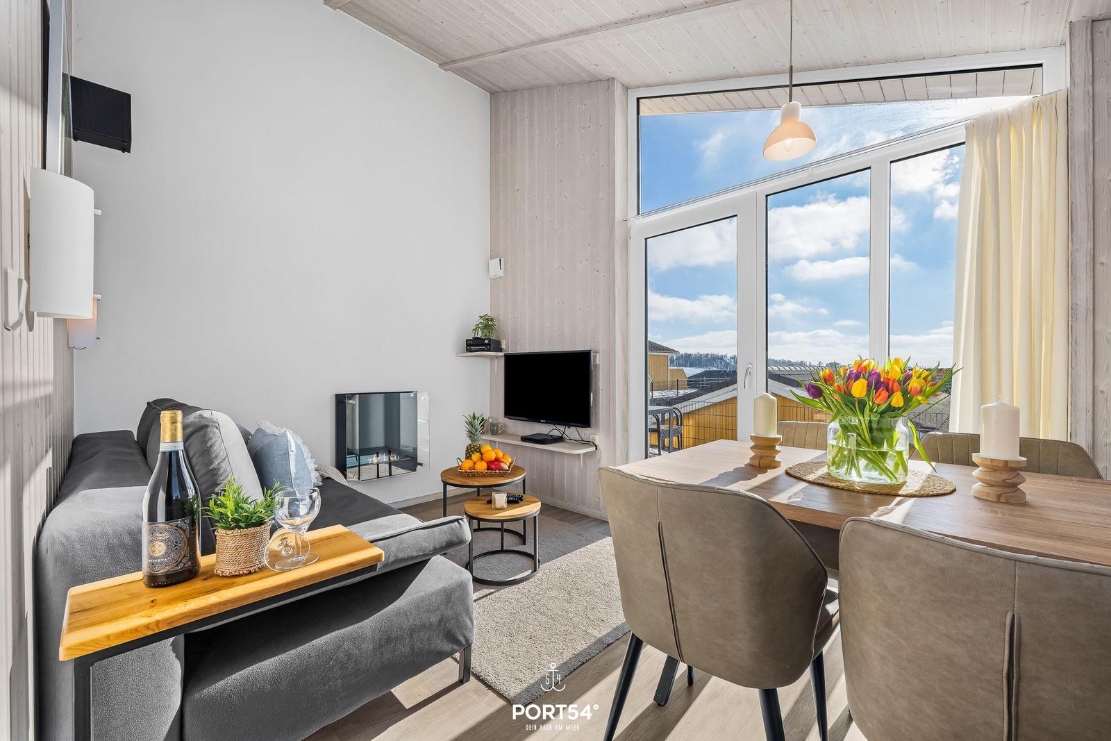 Living and dining area with view of the roof and sky.