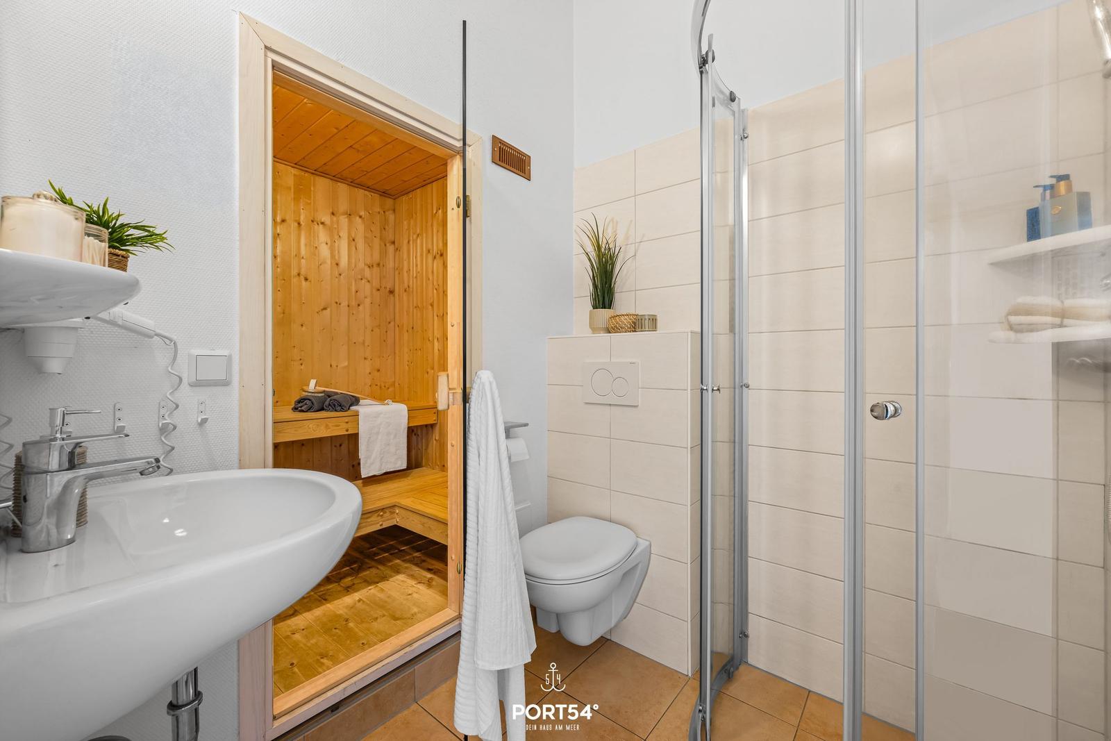Bathroom with shower, toilet, and built-in sauna.