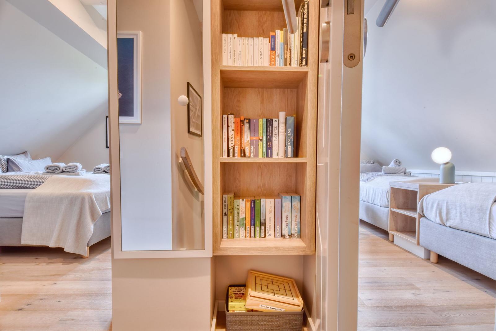A bookshelf with several books and a box with games