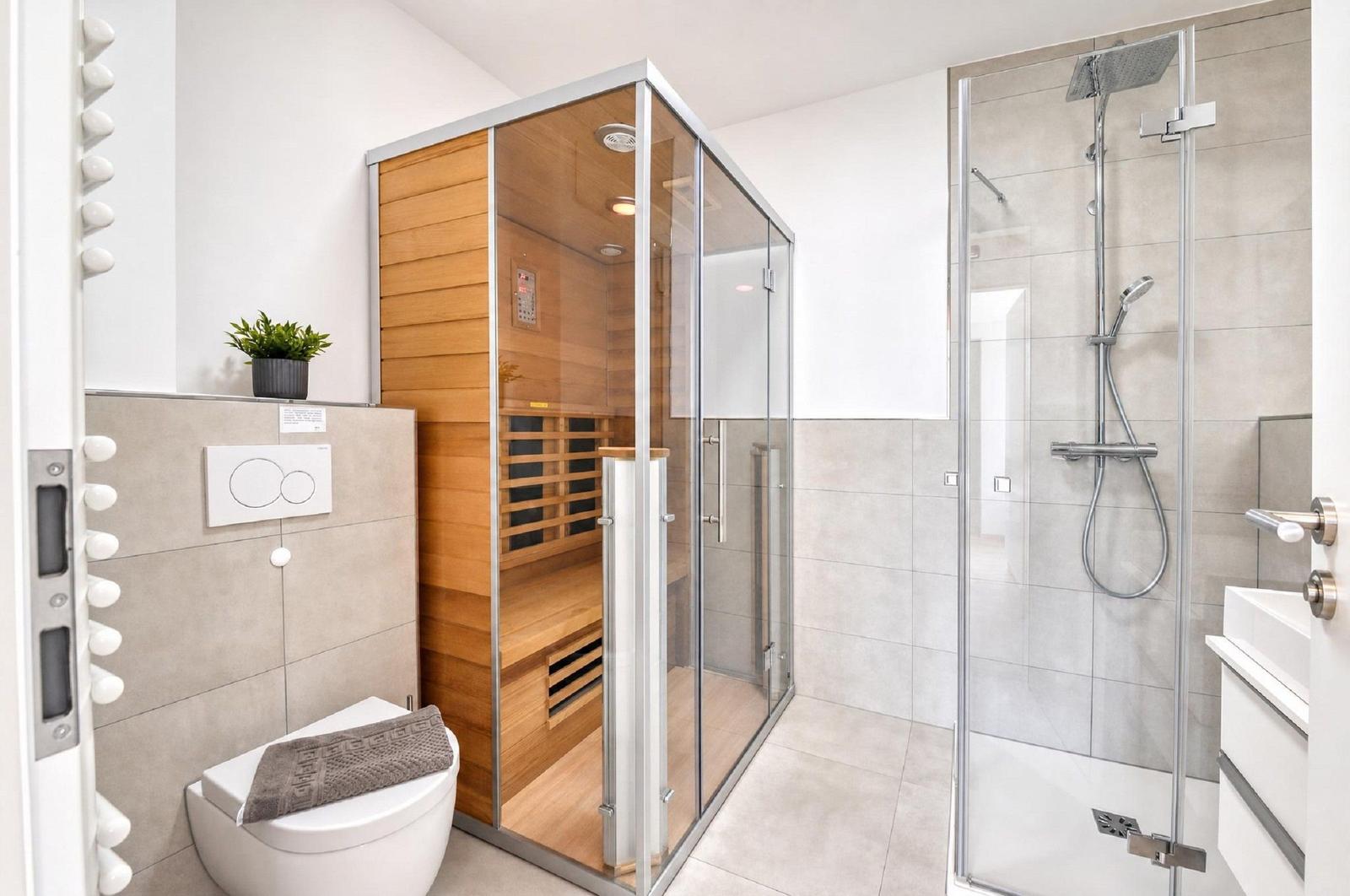 Bad mit Dusche, Sauna und Toilette. Moderne Ausstattung und hell.