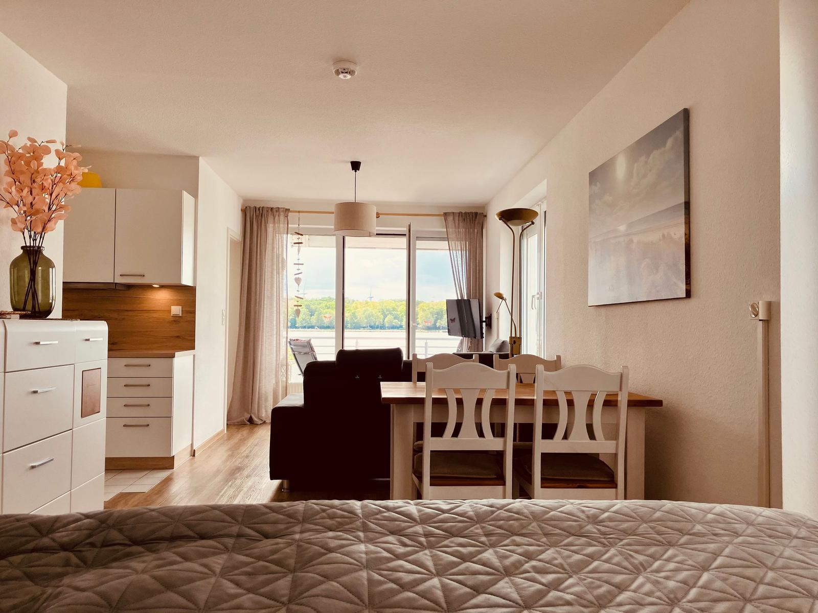 Wohnung mit Essbereich, Küche und Blick auf Wasser.