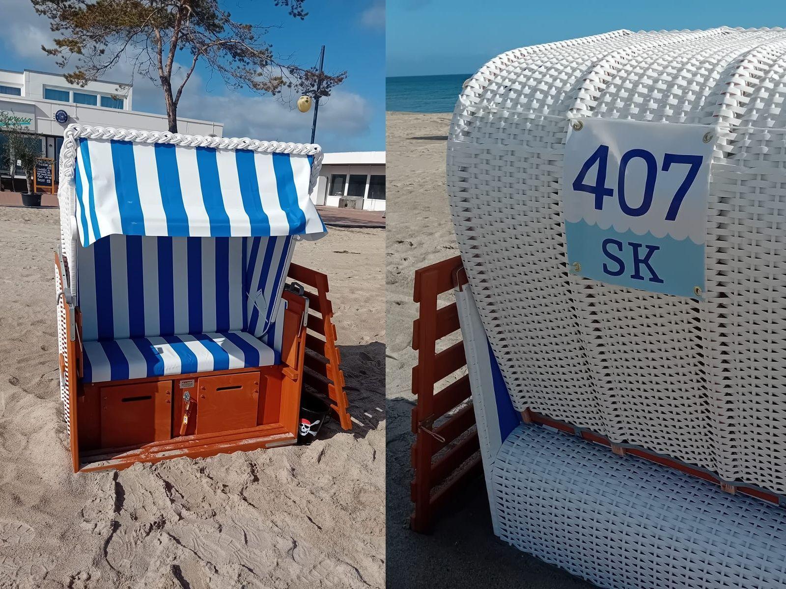 Beach chairs with blue-white fabric and number 407 SK on sandy beach