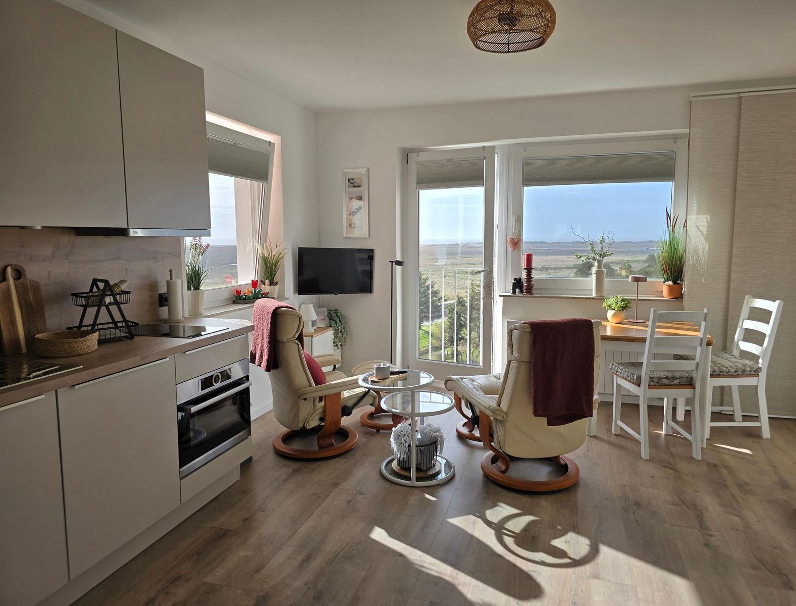 Kitchen, living, and dining area with a view of the landscape.