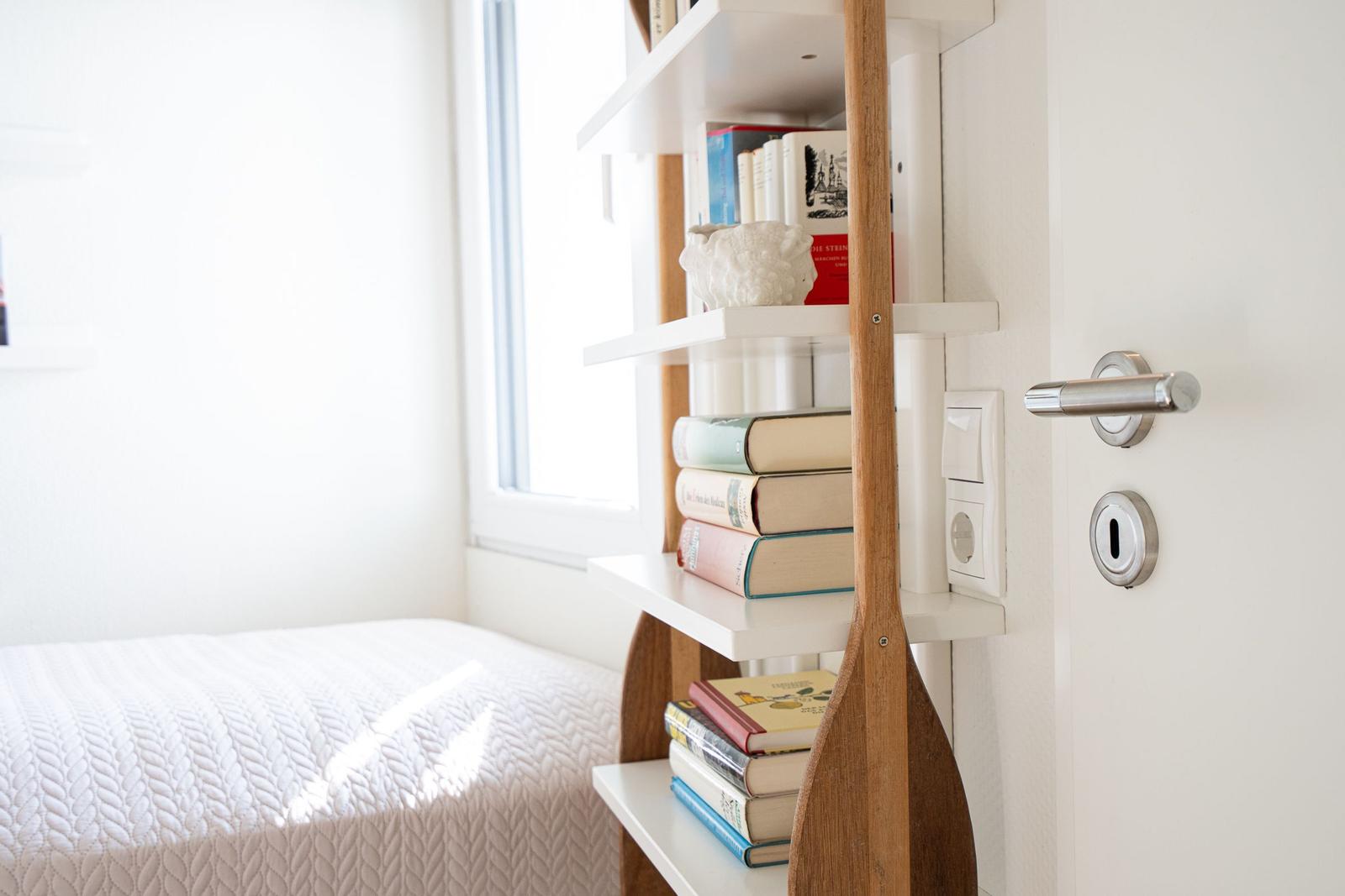 Bedroom with bed, bookshelf, and door