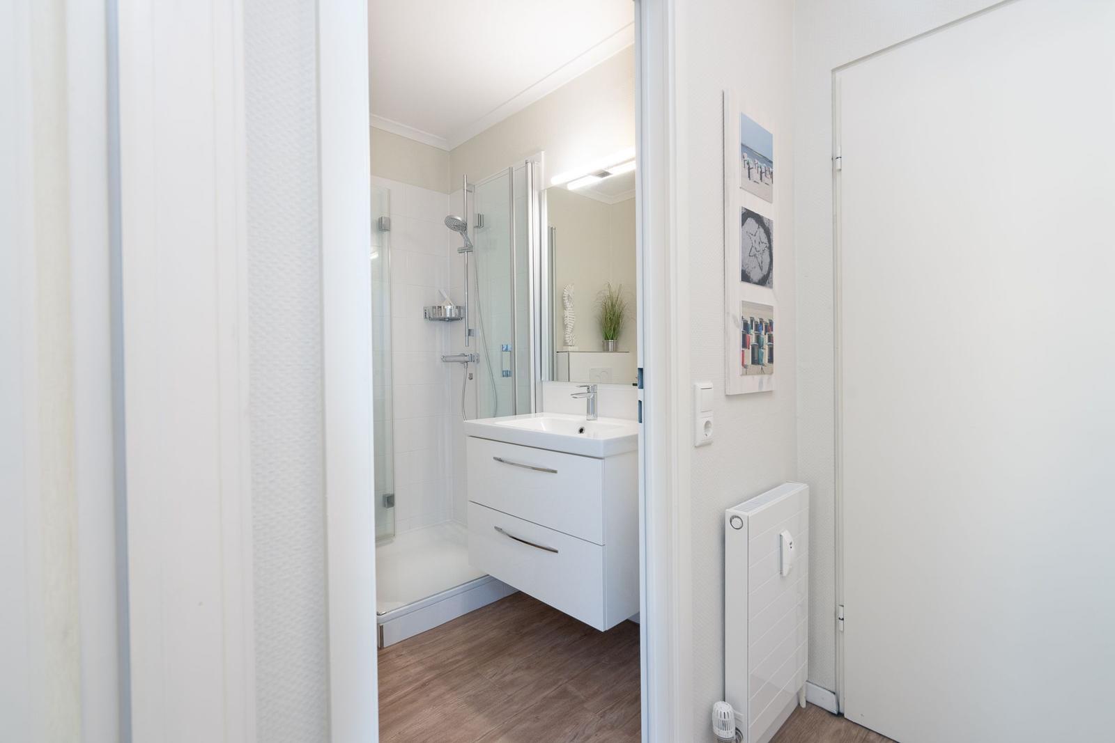 Bathroom with shower, sink, and mirror