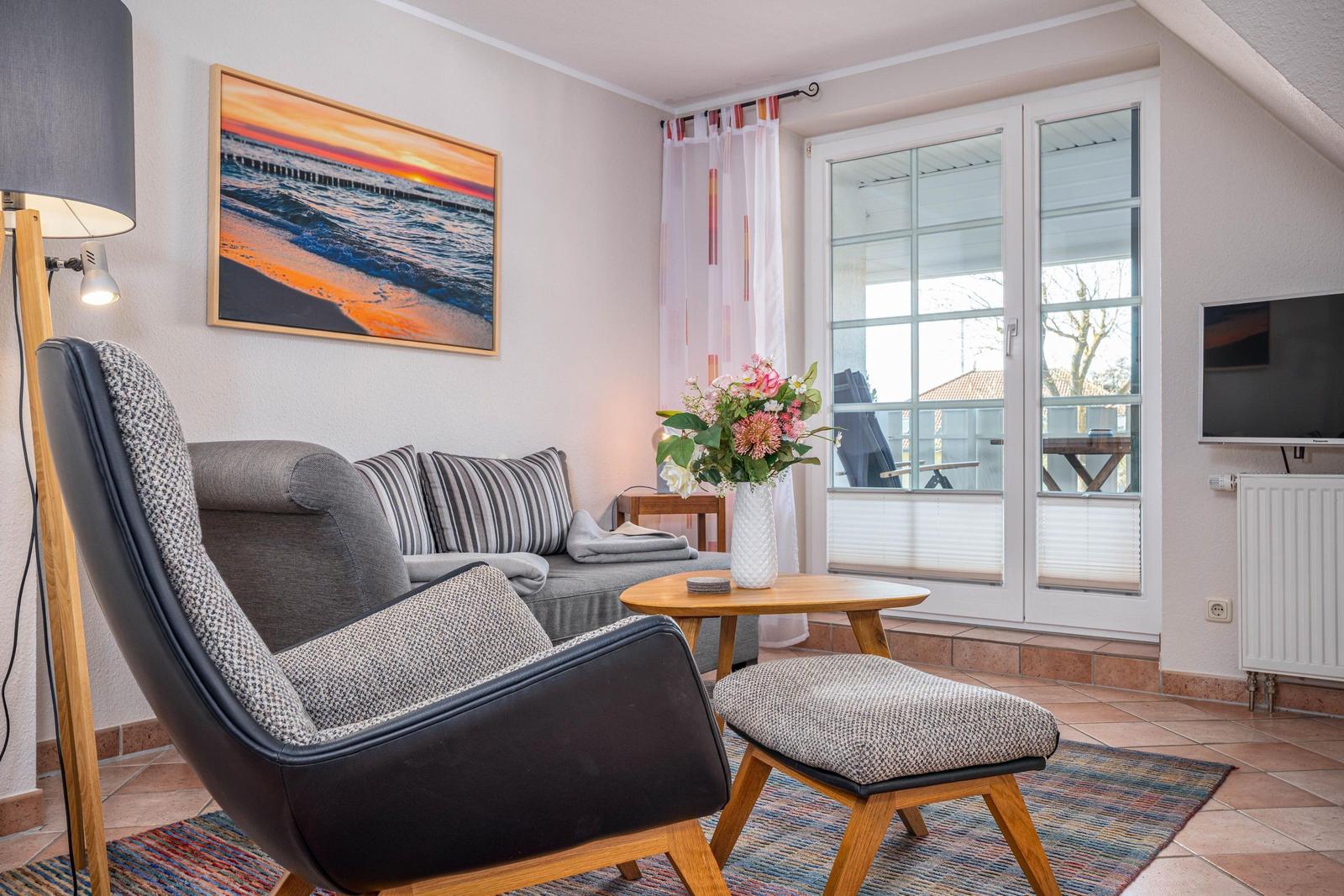 Wohnbereich mit Sofa, Sessel und TV