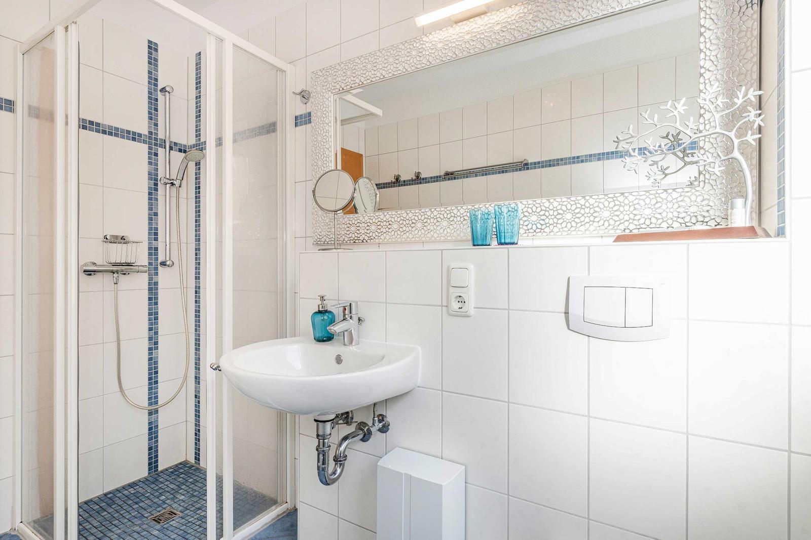 Bathroom with shower, sink, and mirror