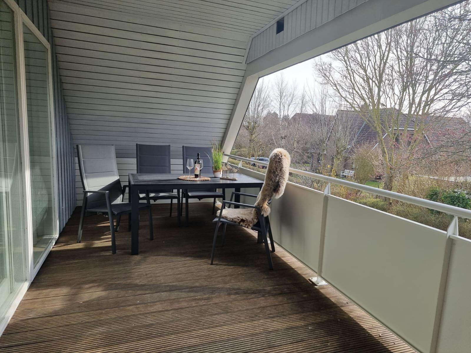 Terrace with table, chairs, and view of the surroundings.