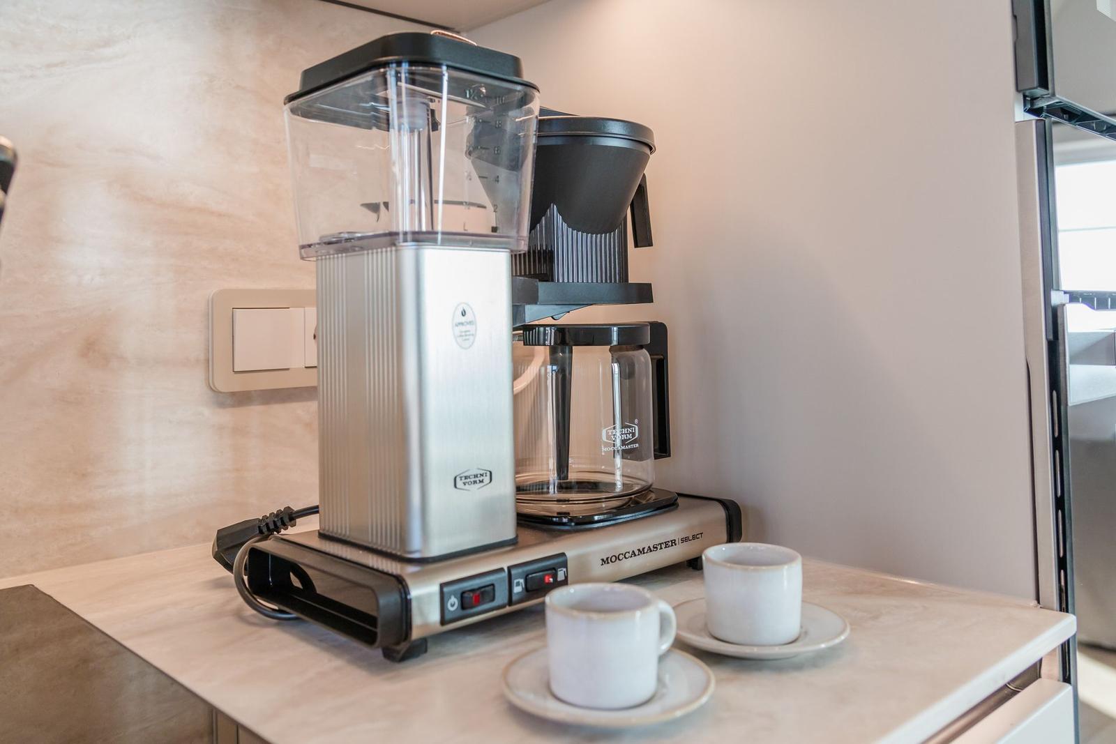 Kaffeemaschine mit zwei Tassen auf Arbeitsfläche