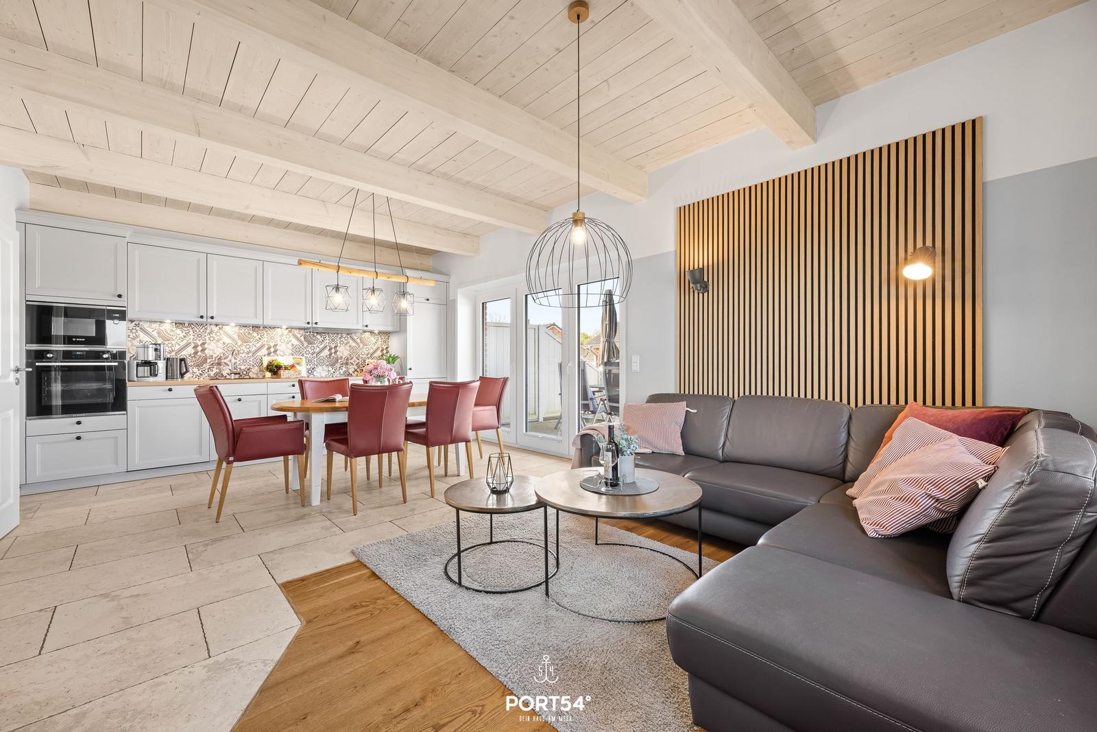 Living and dining area with kitchen, sofa, and dining table.