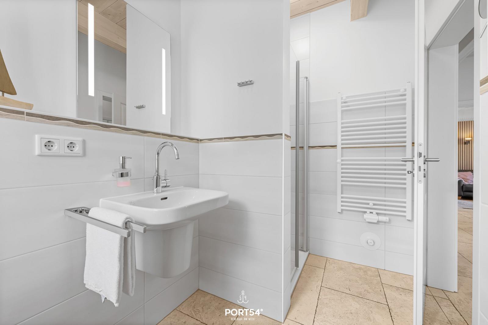 Bathroom with sink, mirror, and shower