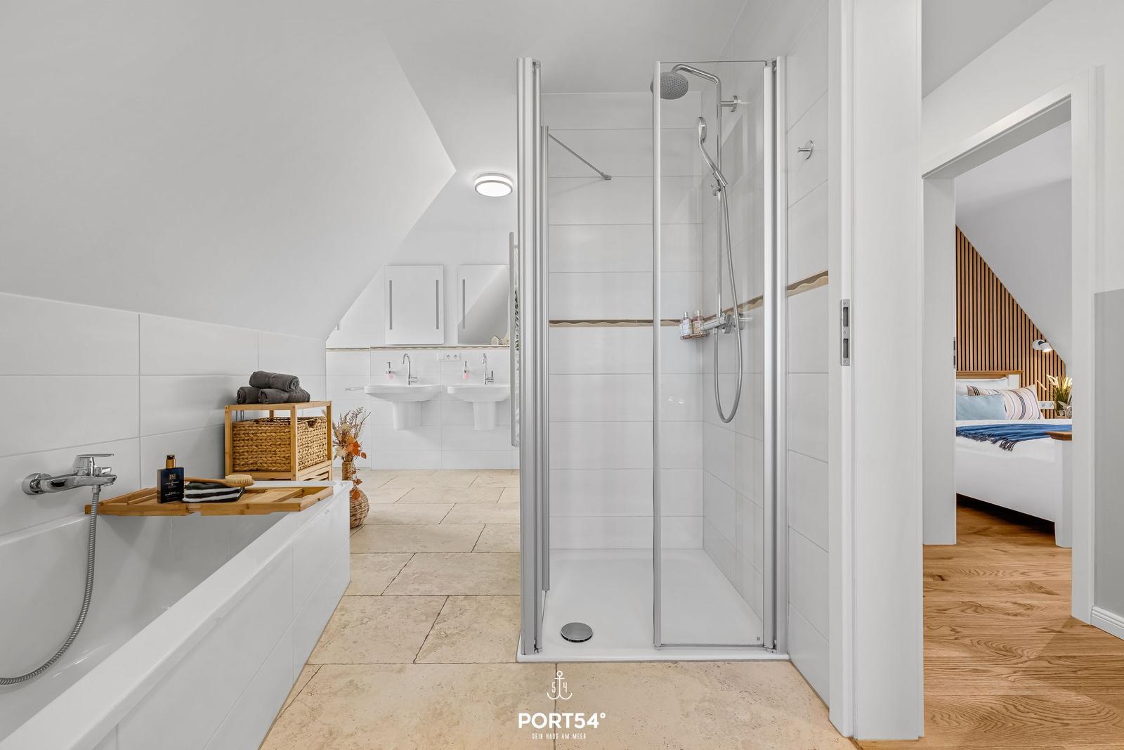 Bathroom with shower, bathtub, and two sinks.