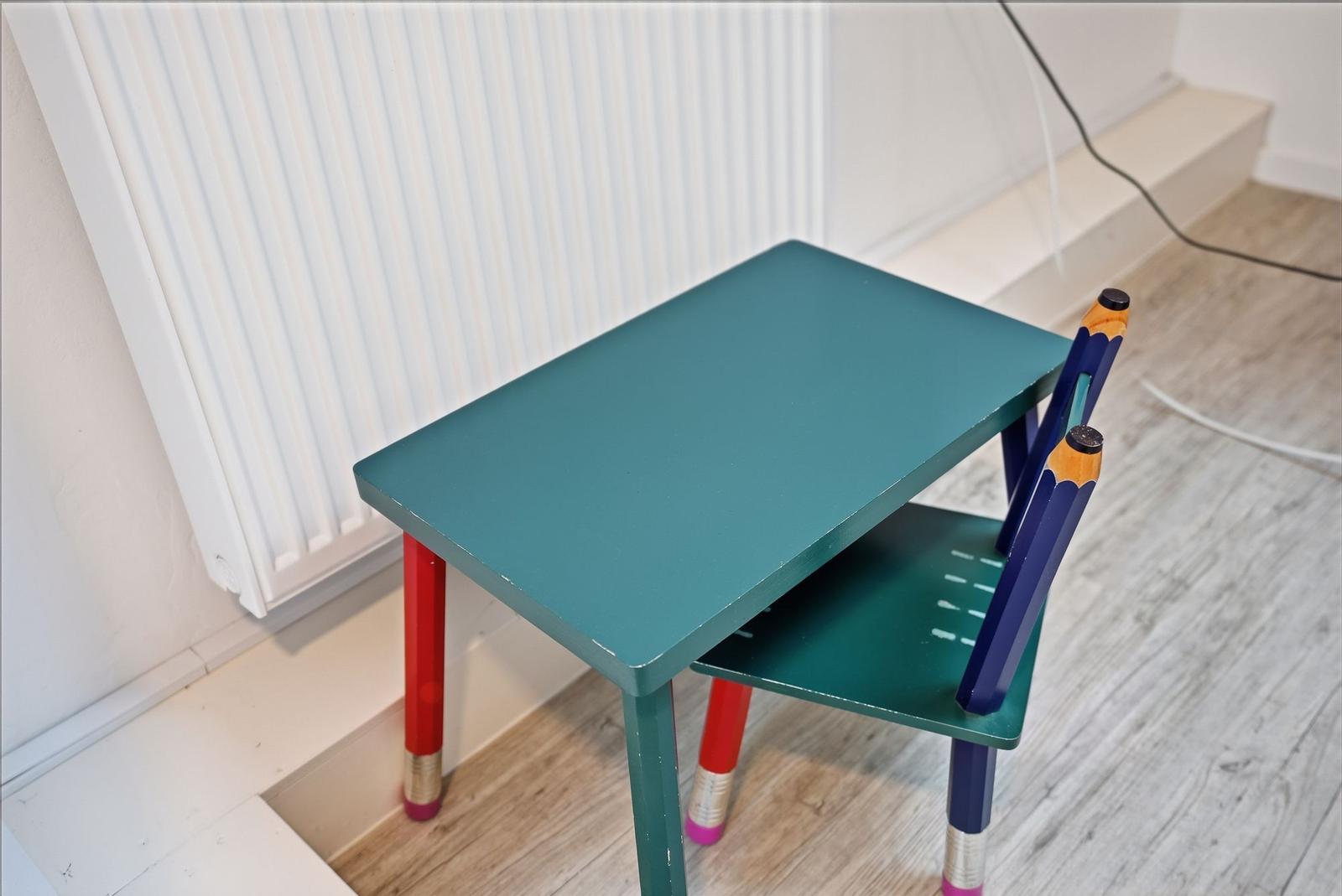 Childs desk and chair with colored pencil legs.