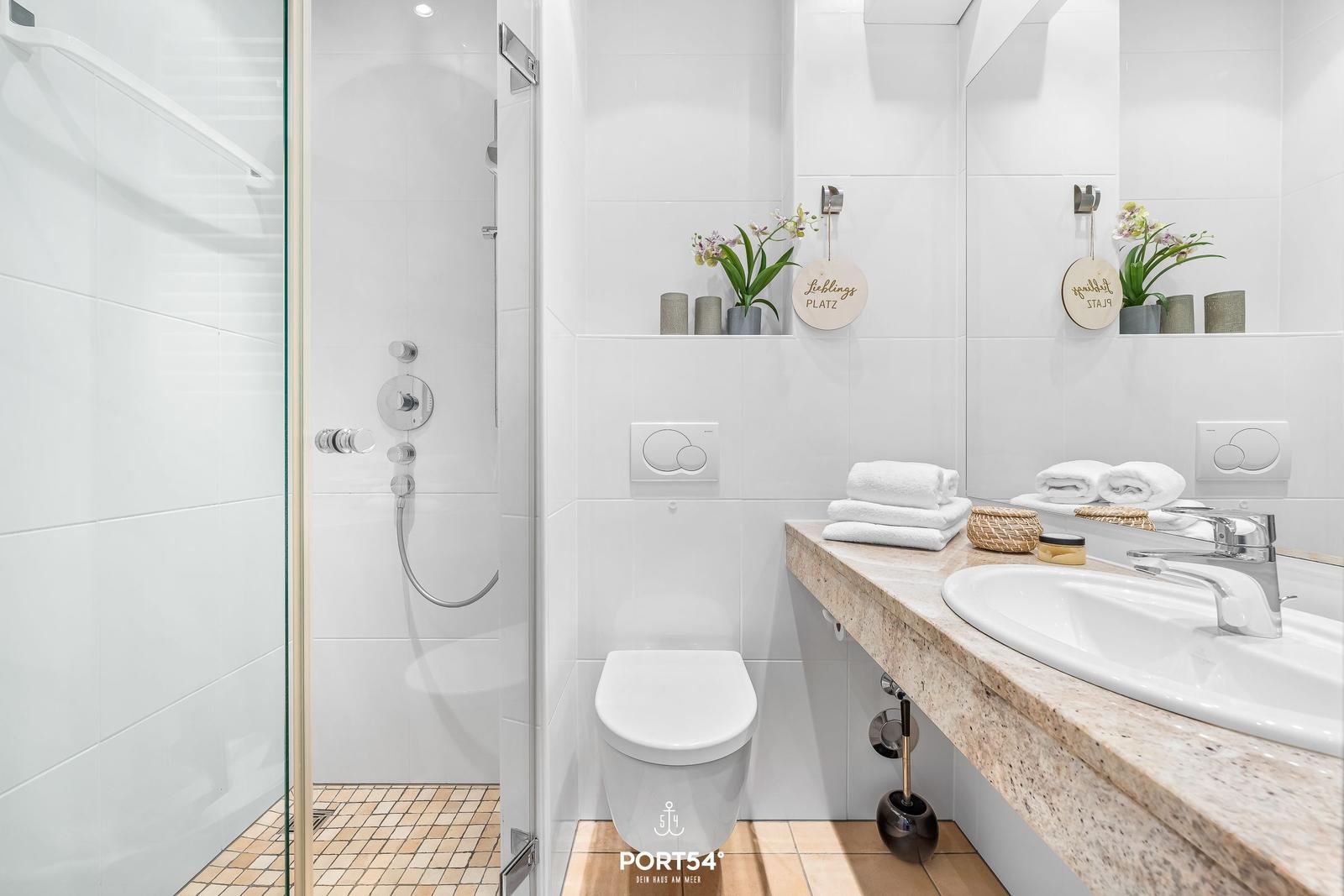Bathroom with shower, toilet, and sink with mirror