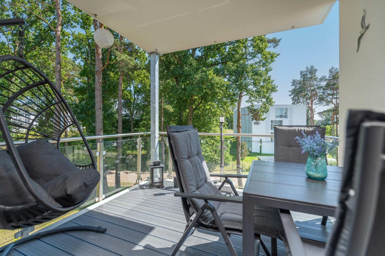 Terrasse mit Sitzgelegenheiten und Blick in den Wald.