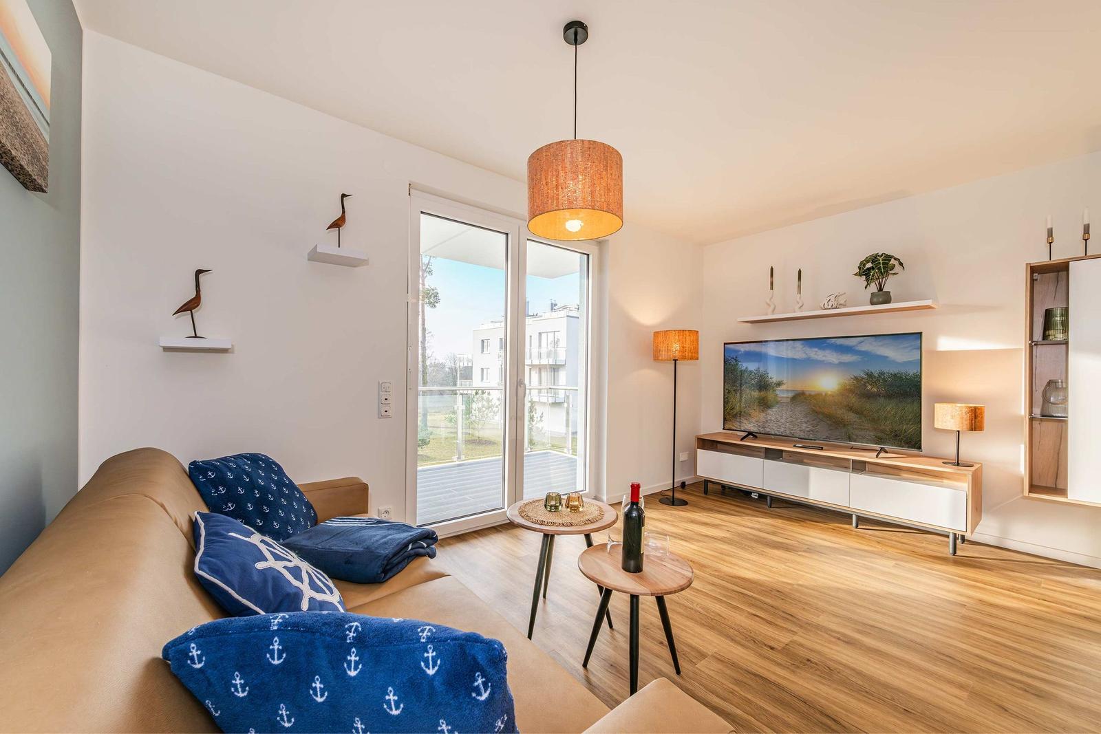 Living room with sofa, TV, and terrace door.
