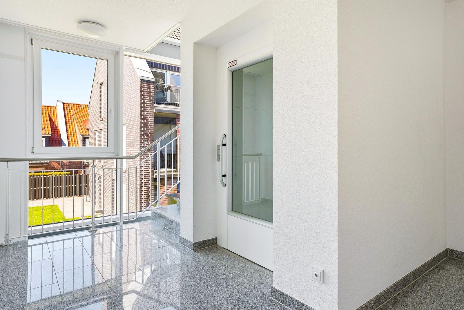 Eingangsbereich mit Glas-Tür und Fensterblick auf die Straße.