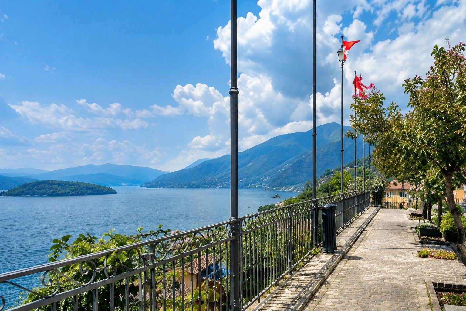 Path along the lake with view of mountains and flags.
