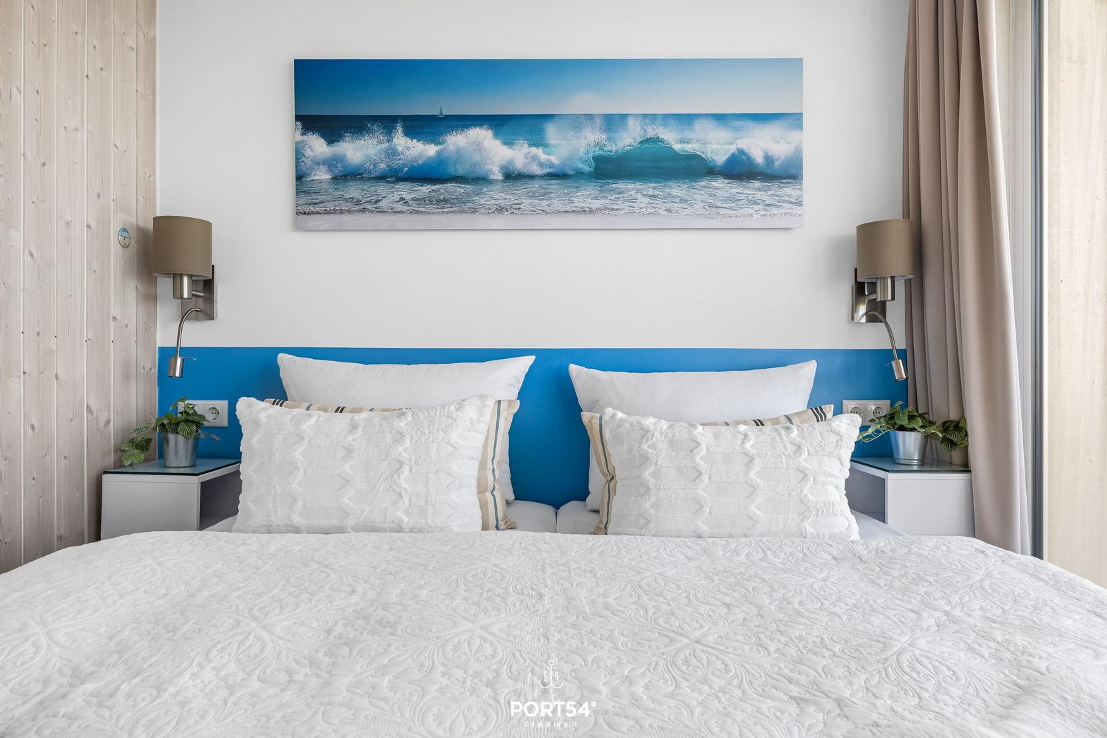 Bedroom with bed, wall art, and nightstands