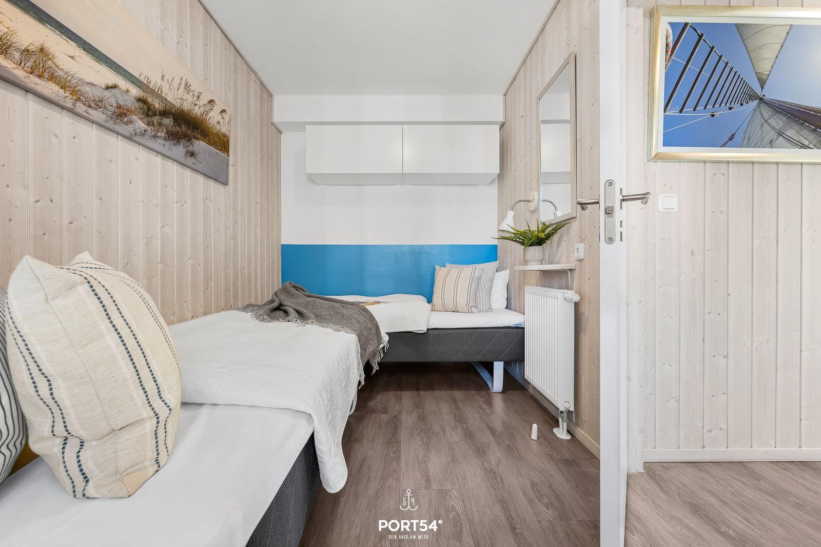 Bedroom with bed, wall art, and mirror