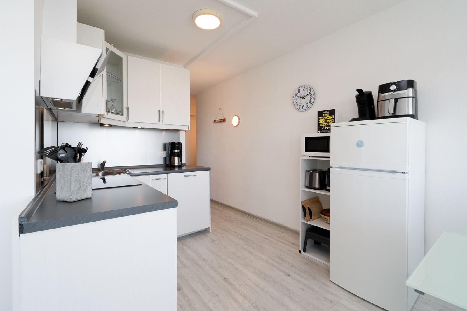 Kitchen with white cabinets, countertop, and appliances.