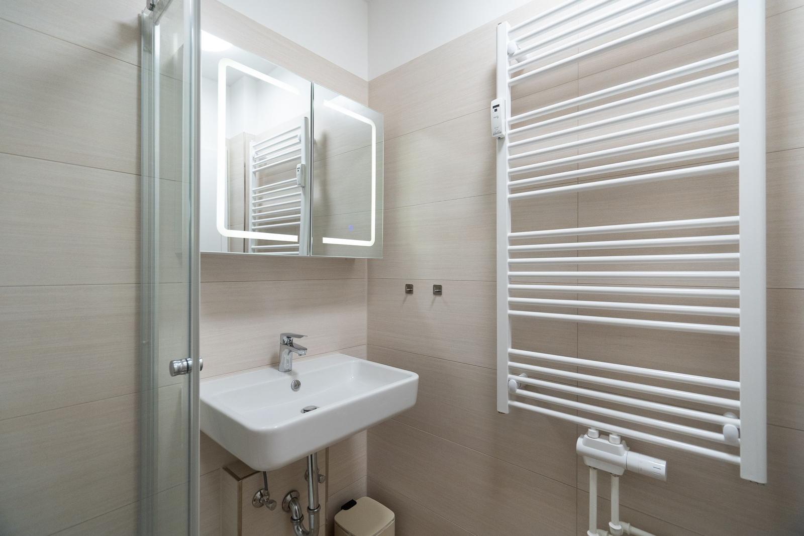 Bathroom with sink, mirror cabinet, and heater